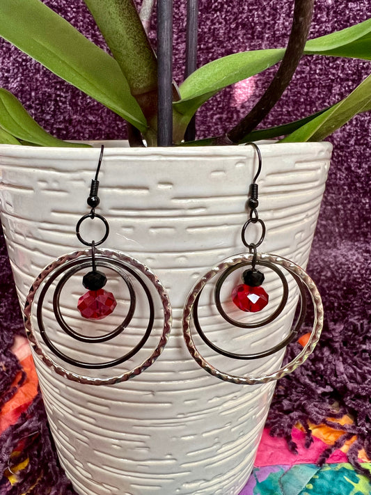 Earrings- Black coated stainless steel ear hooks with gunmetal and silver hoops. Red and black crystals.