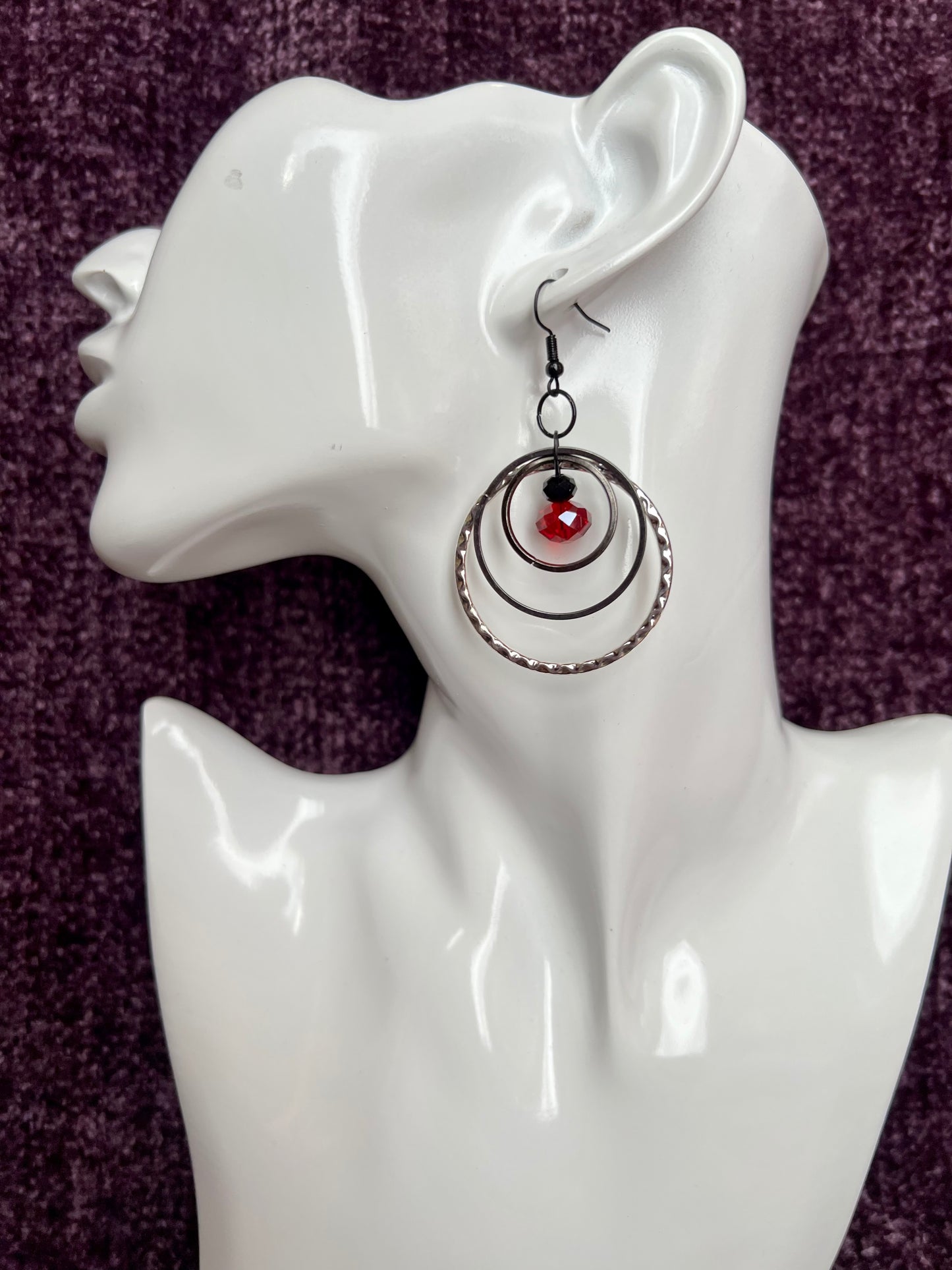 Earrings- Black coated stainless steel ear hooks with gunmetal and silver hoops. Red and black crystals.