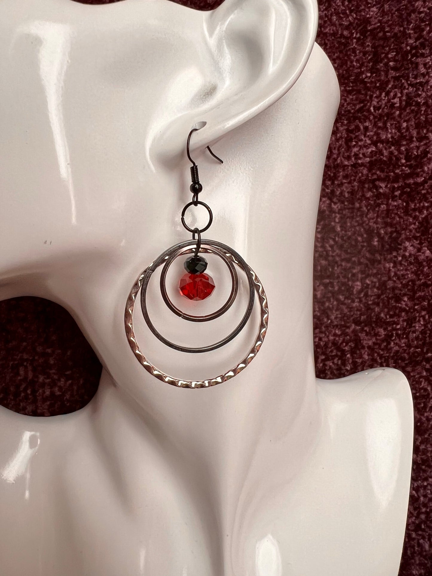 Earrings- Black coated stainless steel ear hooks with gunmetal and silver hoops. Red and black crystals.