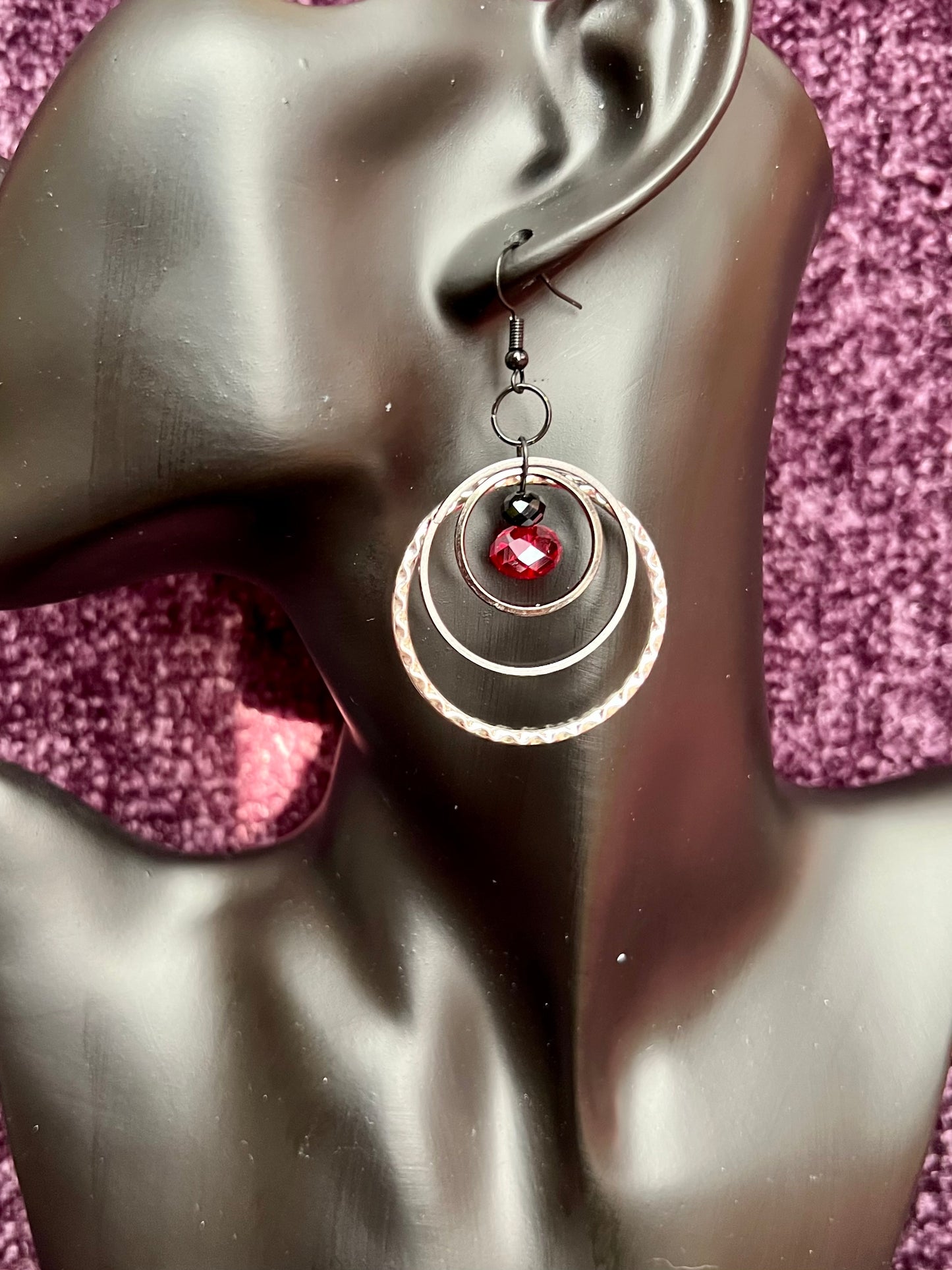 Earrings- Black coated stainless steel ear hooks with gunmetal and silver hoops. Red and black crystals.
