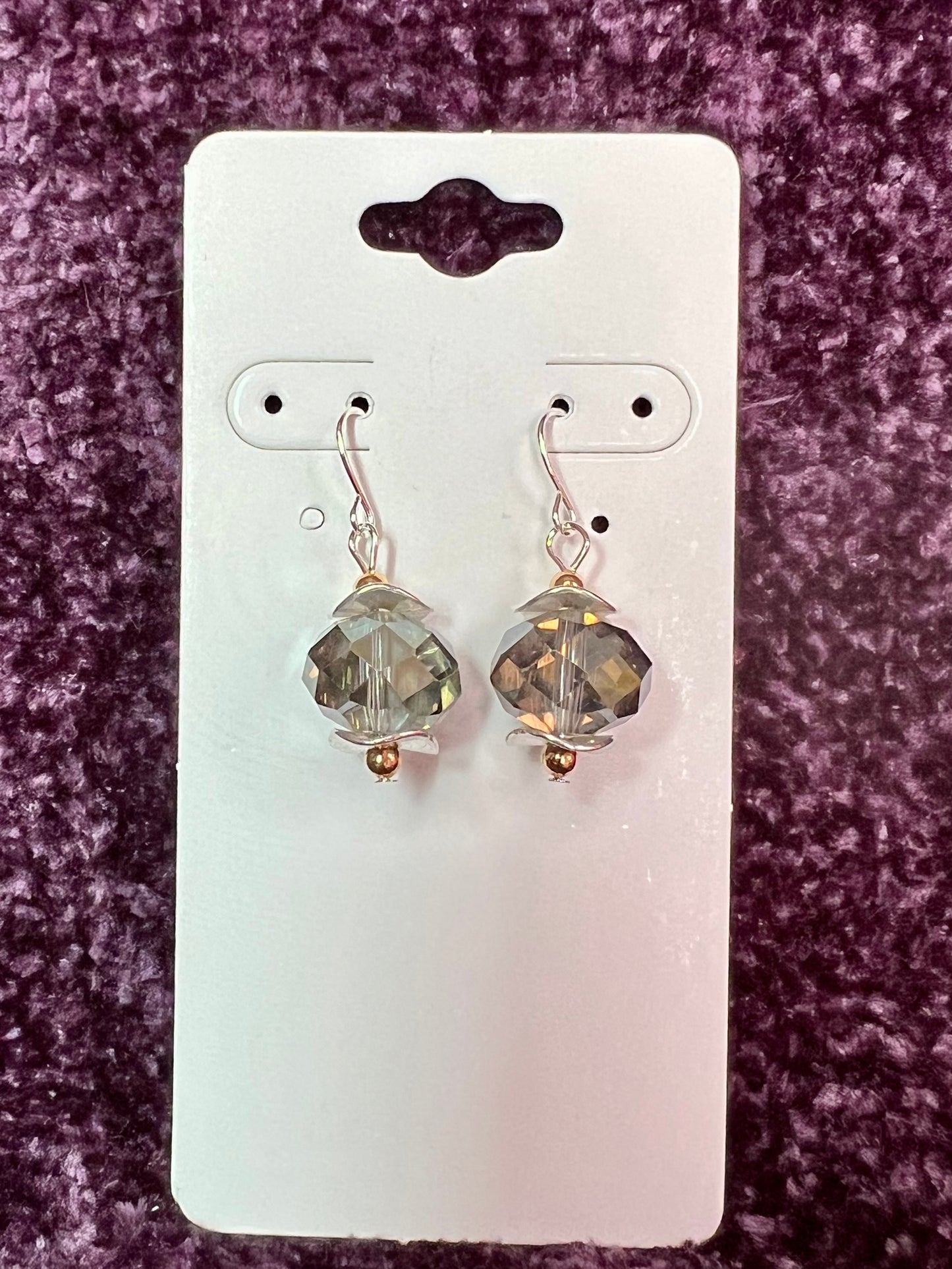 Earrings- Gold and silver plated metal with a crystal that has a unique luster.