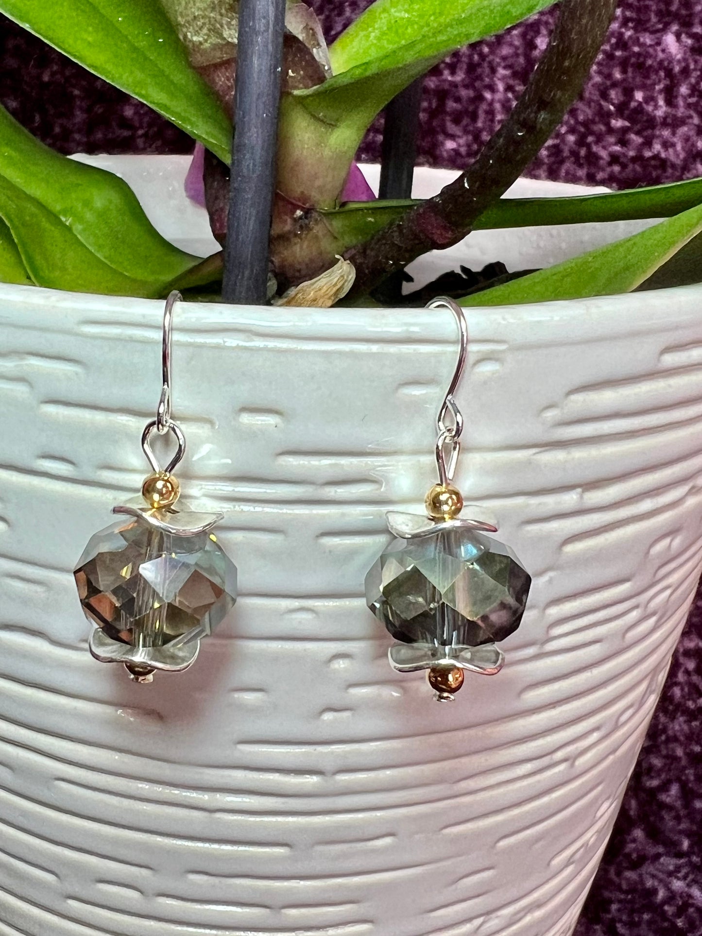 Earrings- Gold and silver plated metal with a crystal that has a unique luster.