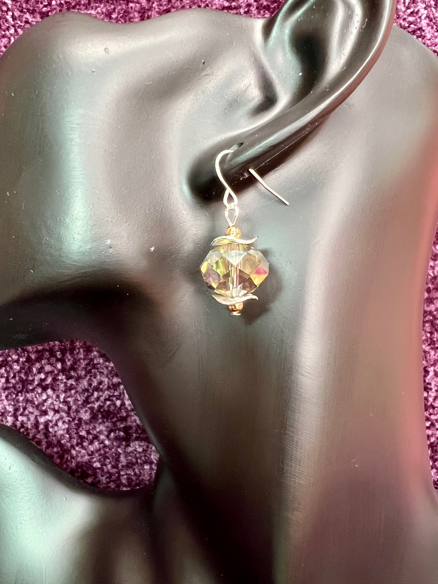 Earrings- Gold and silver plated metal with a crystal that has a unique luster.