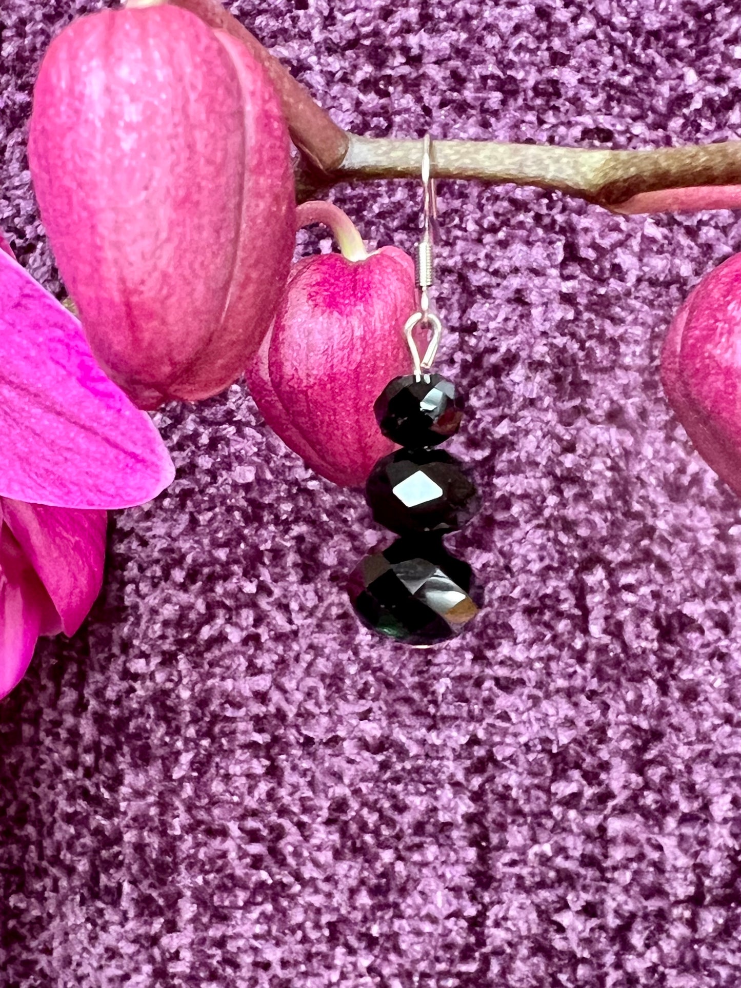 Earrings- Stainless steel ear hooks, silver plated metal with opaque black crystals.