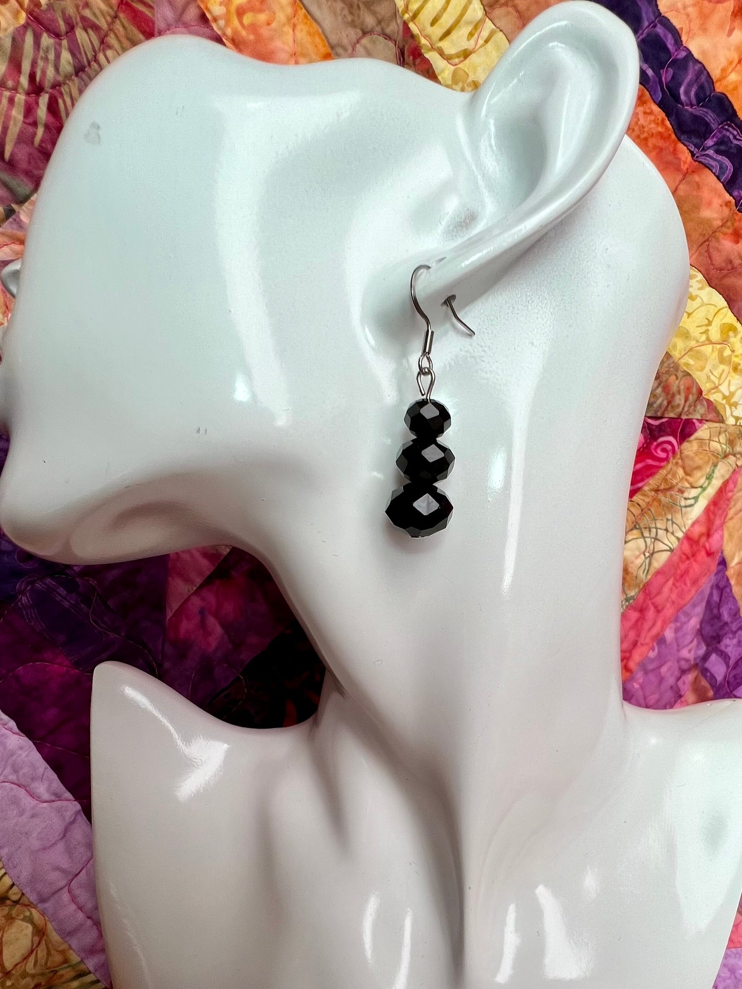 Earrings- Stainless steel ear hooks, silver plated metal with opaque black crystals.