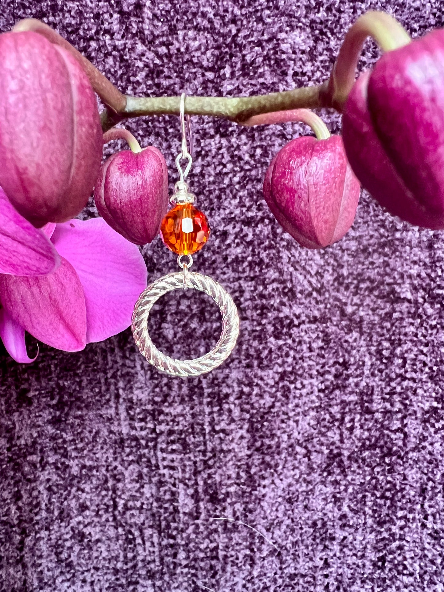 Earrings- Silver plated metal with orange crystal.