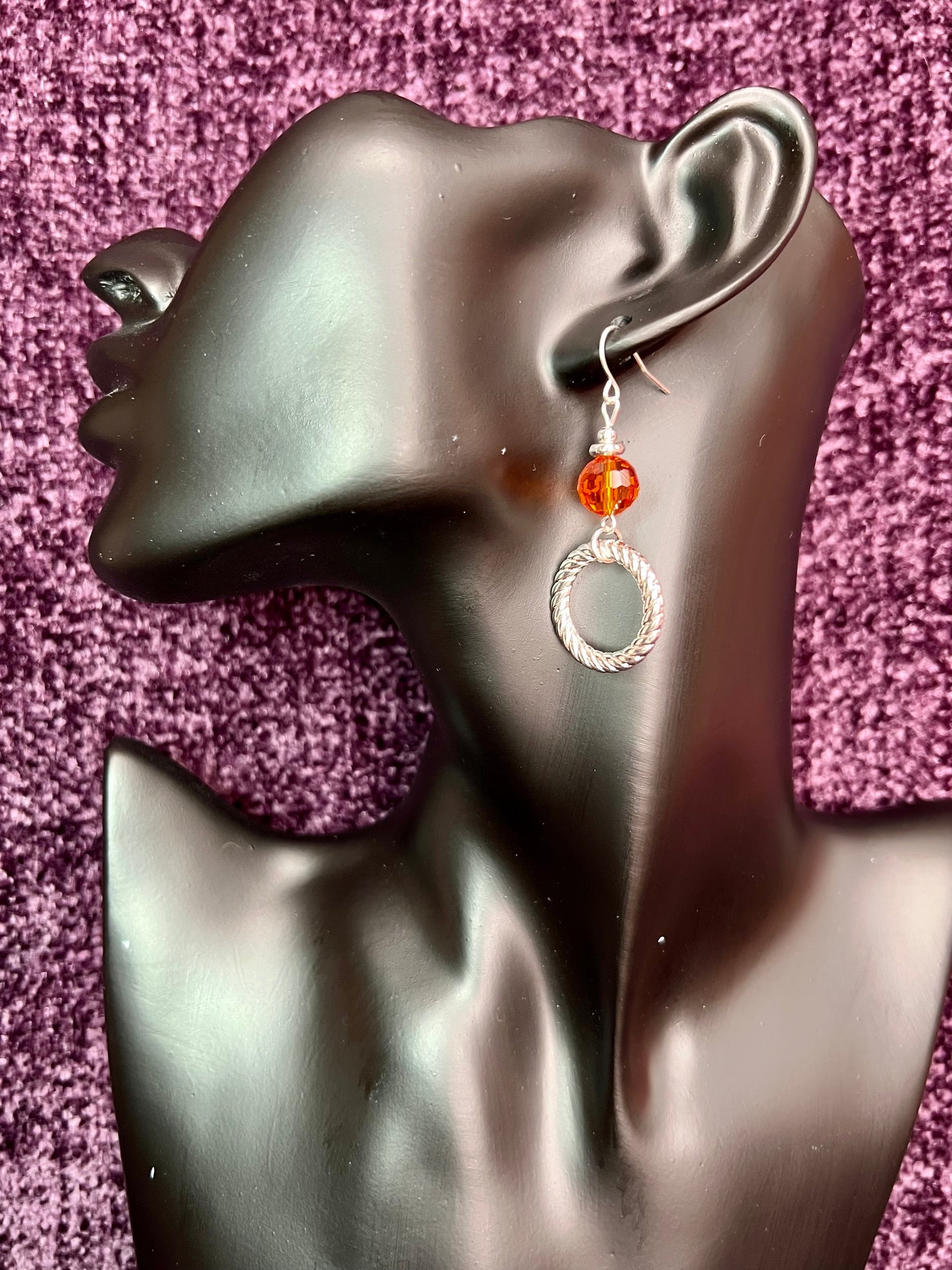 Earrings- Silver plated metal with orange crystal.