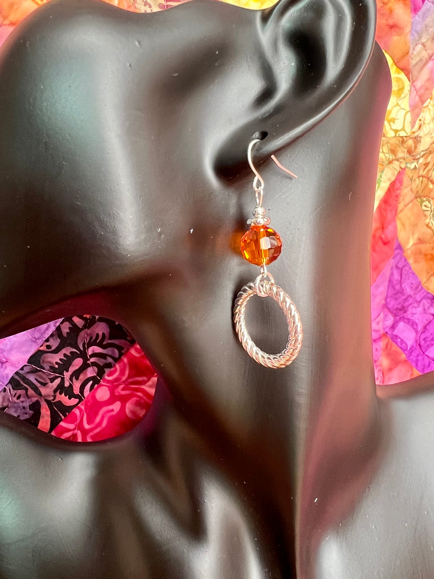 Earrings- Silver plated metal with orange crystal.