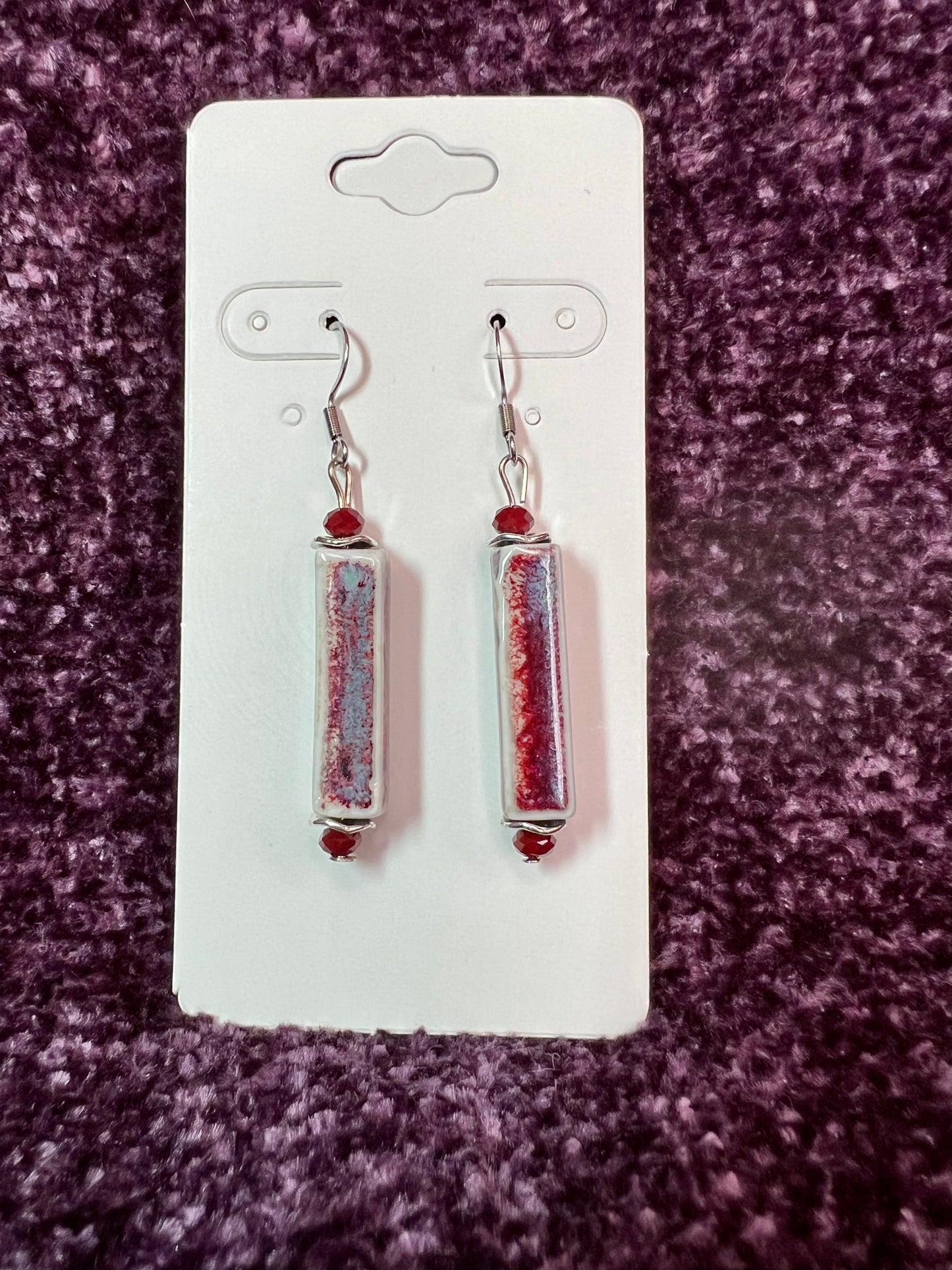 Earrings- Stainless steel ear hooks, red crystals, and ceramic rectangular tube beads in red and blue glaze.