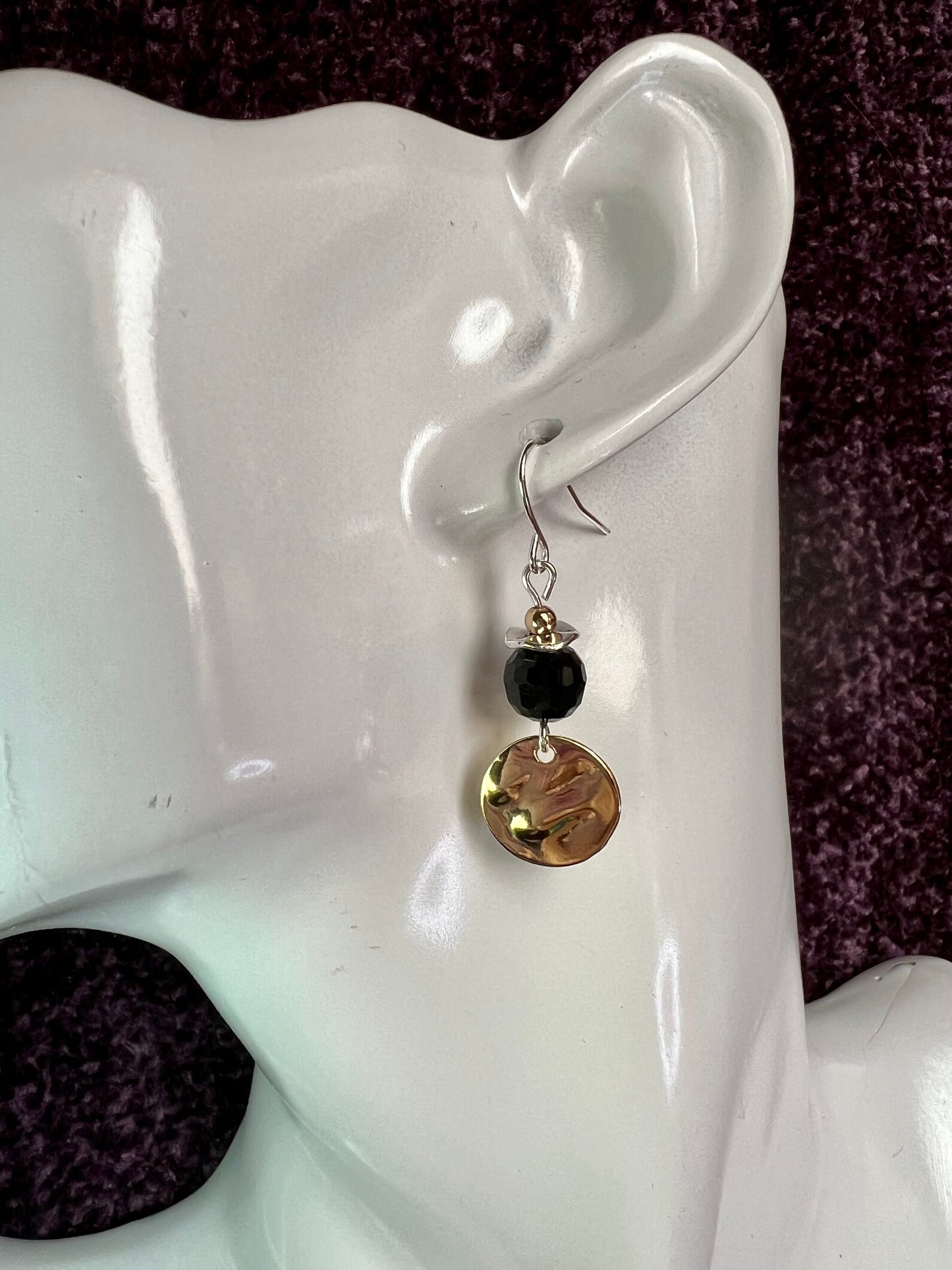 Earrings- Gold and silver plated metal with opaque black crystal beads.