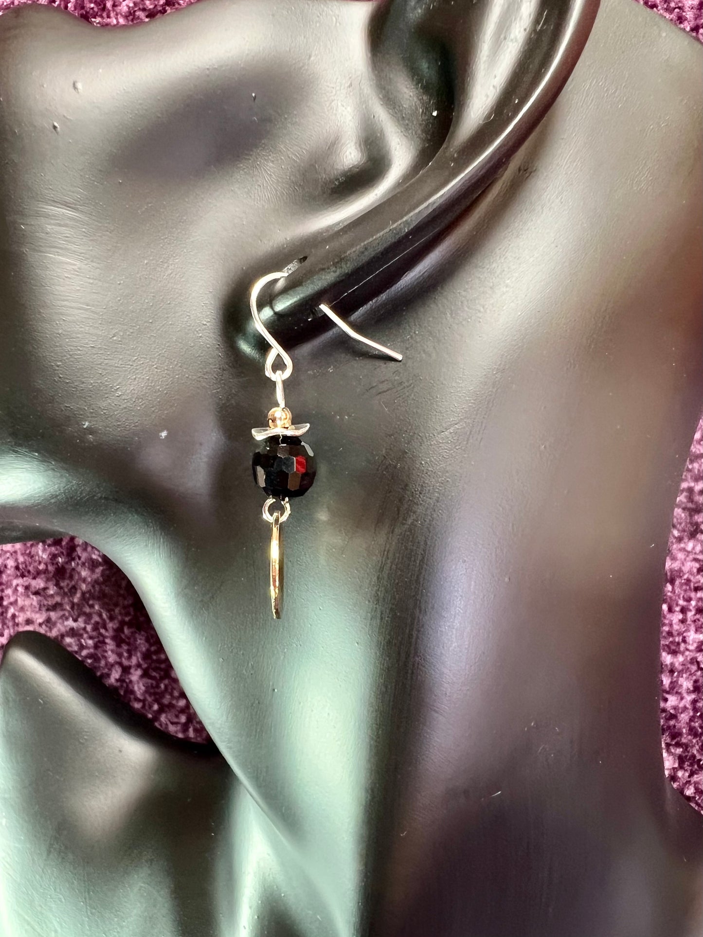 Earrings- Gold and silver plated metal with opaque black crystal beads.