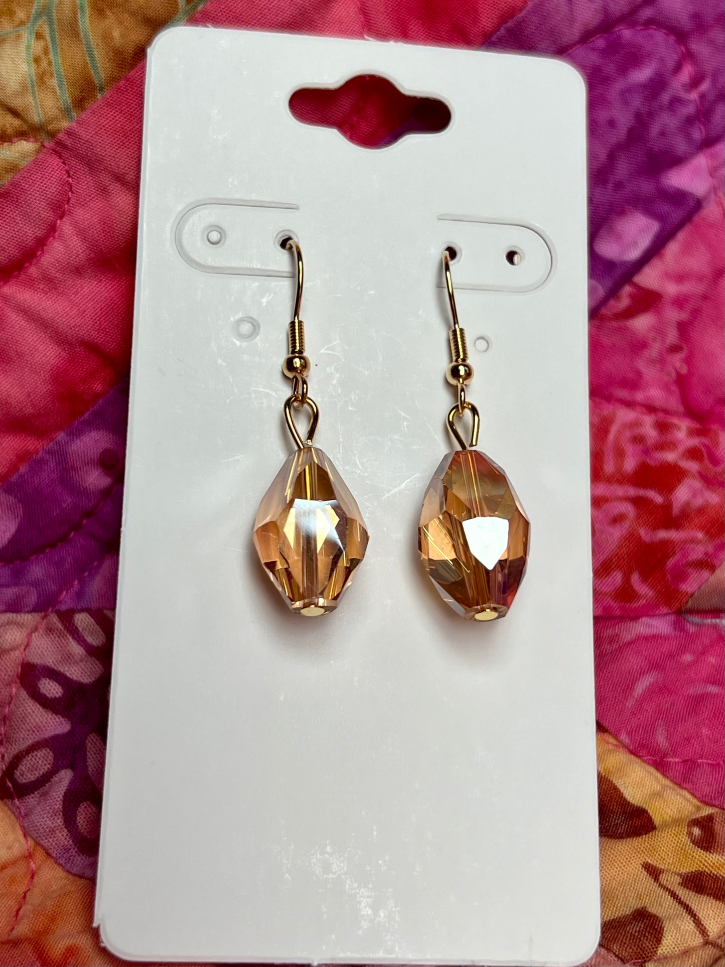 Earrings- Gold plated stainless steel ear hooks, gold plated metal with yellow/orange crystals.