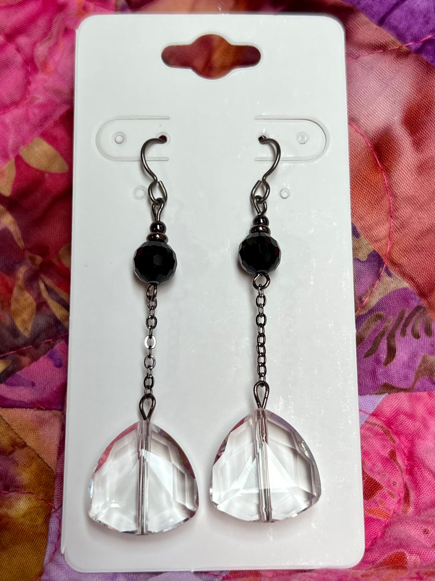 Earrings- Titanium ear hooks, gunmetal plated metal, opaque black round crystal, and trillion shaped crystals.