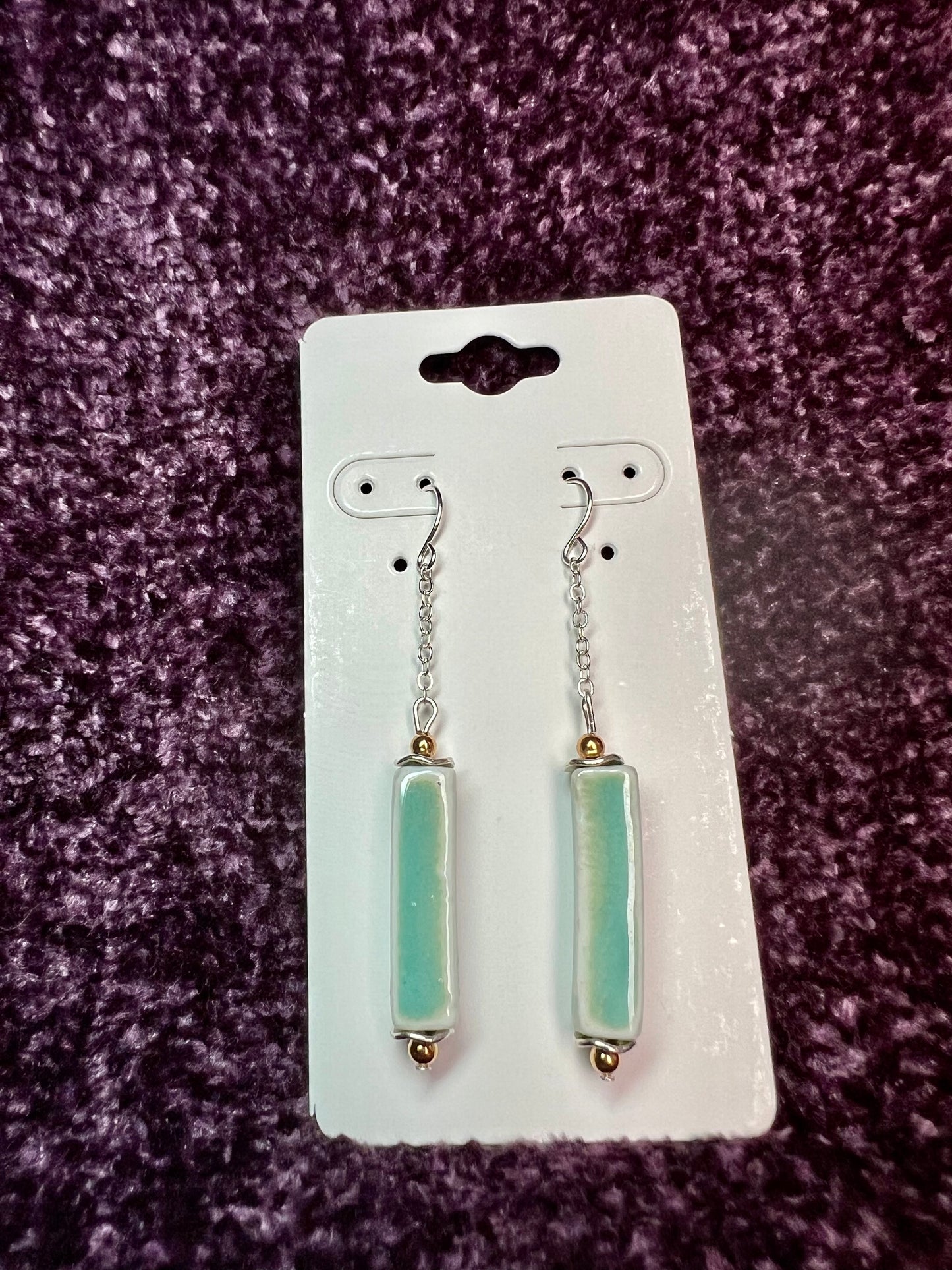 Earrings- Silver plated metal and gold plated round beads. Ceramic rectangular tube beads with a sea foam green glaze.