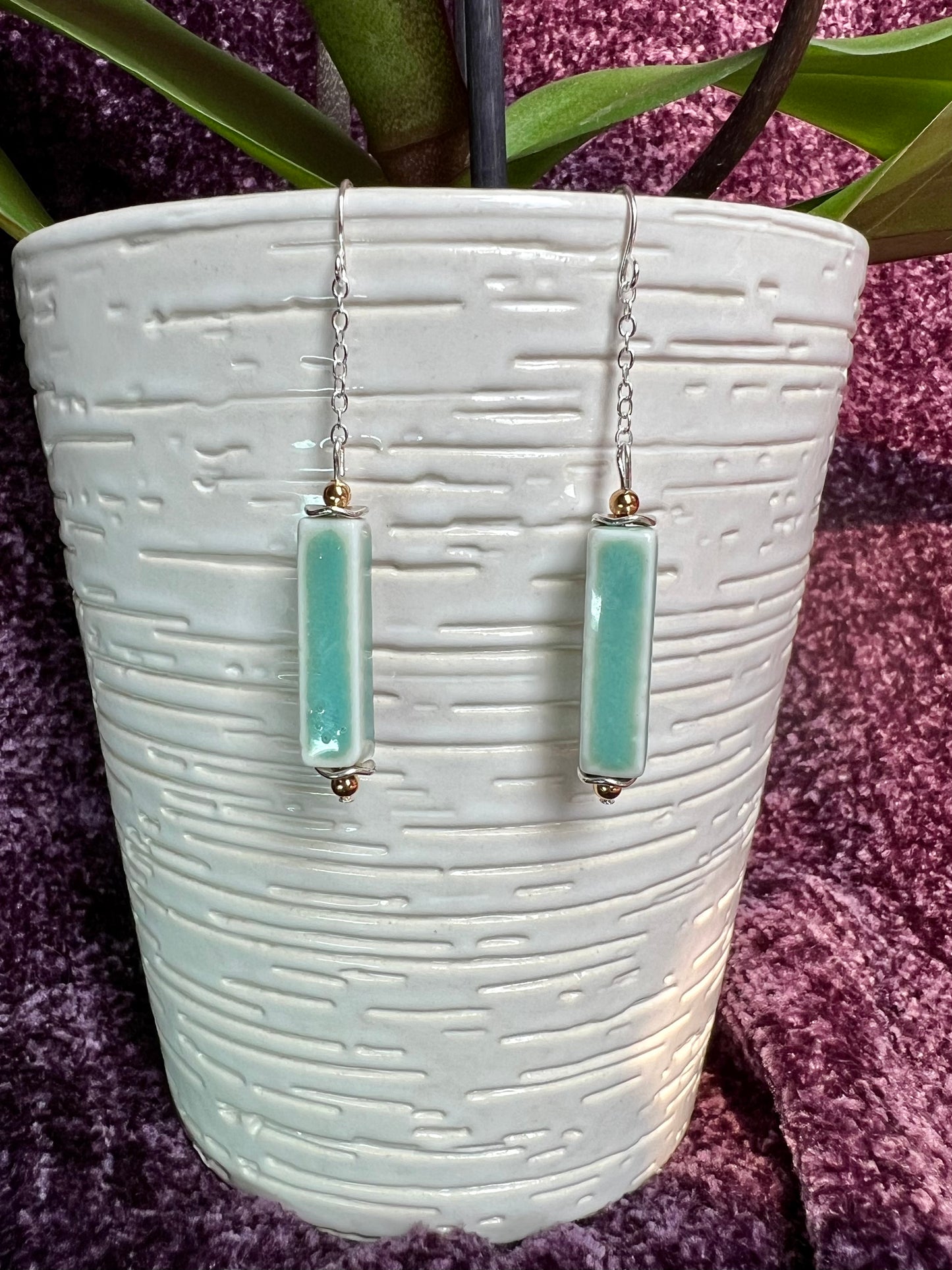 Earrings- Silver plated metal and gold plated round beads. Ceramic rectangular tube beads with a sea foam green glaze.