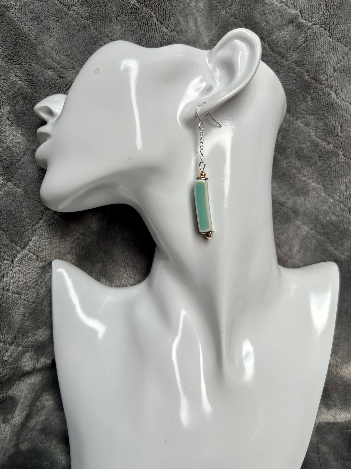 Earrings- Silver plated metal and gold plated round beads. Ceramic rectangular tube beads with a sea foam green glaze.