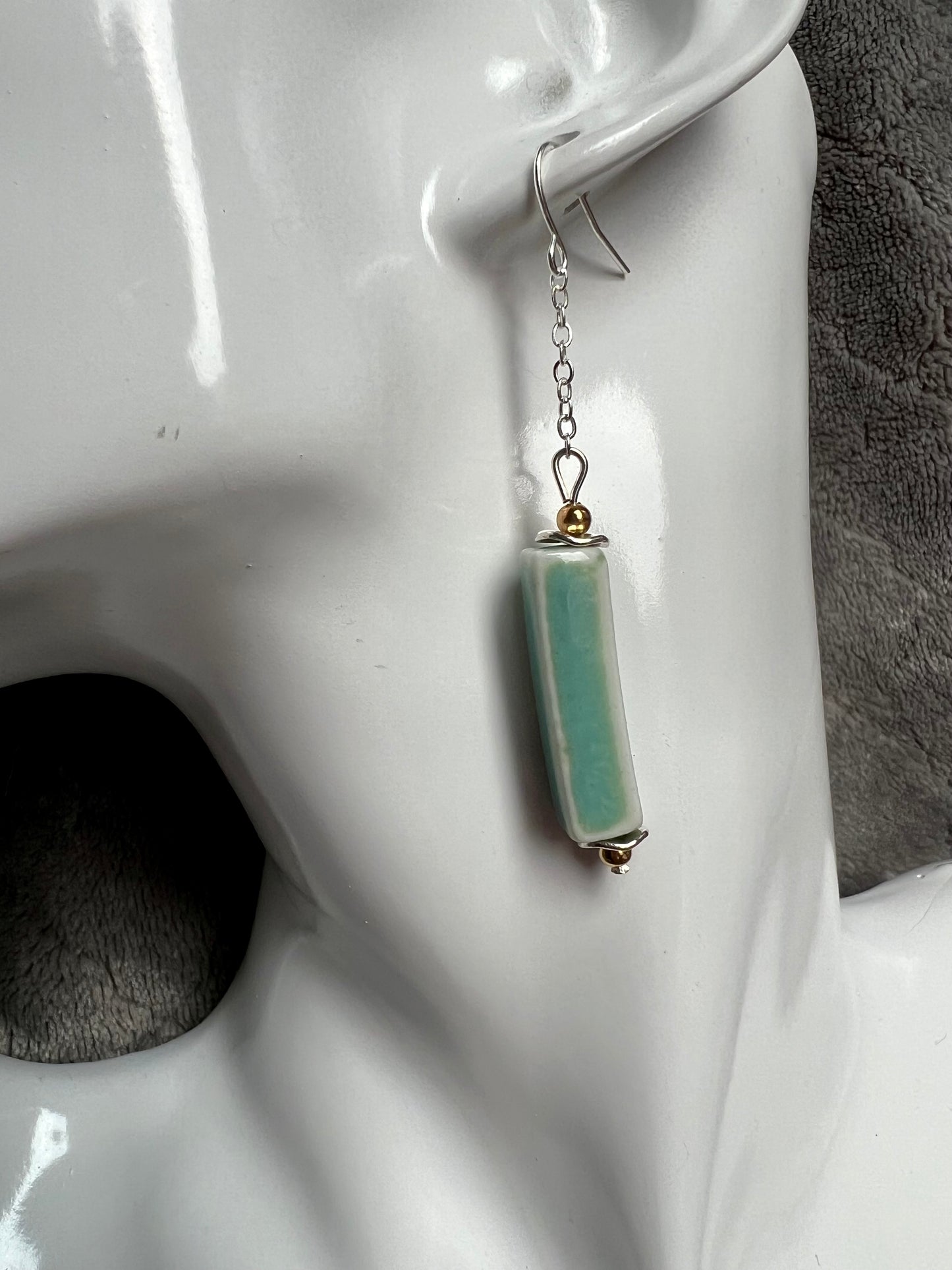 Earrings- Silver plated metal and gold plated round beads. Ceramic rectangular tube beads with a sea foam green glaze.