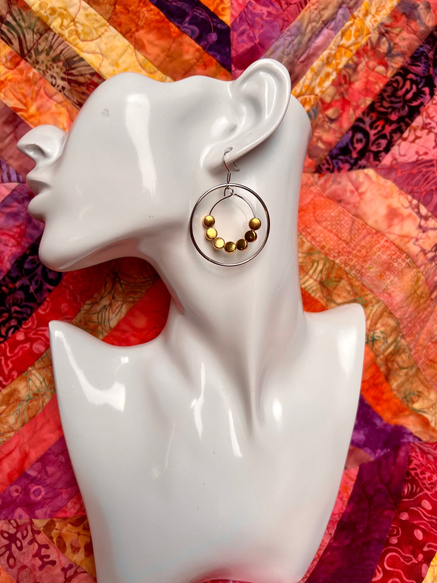 Earrings- Stainless steel ear wires, silver plated metal with gold plated metal coin shaped beads.