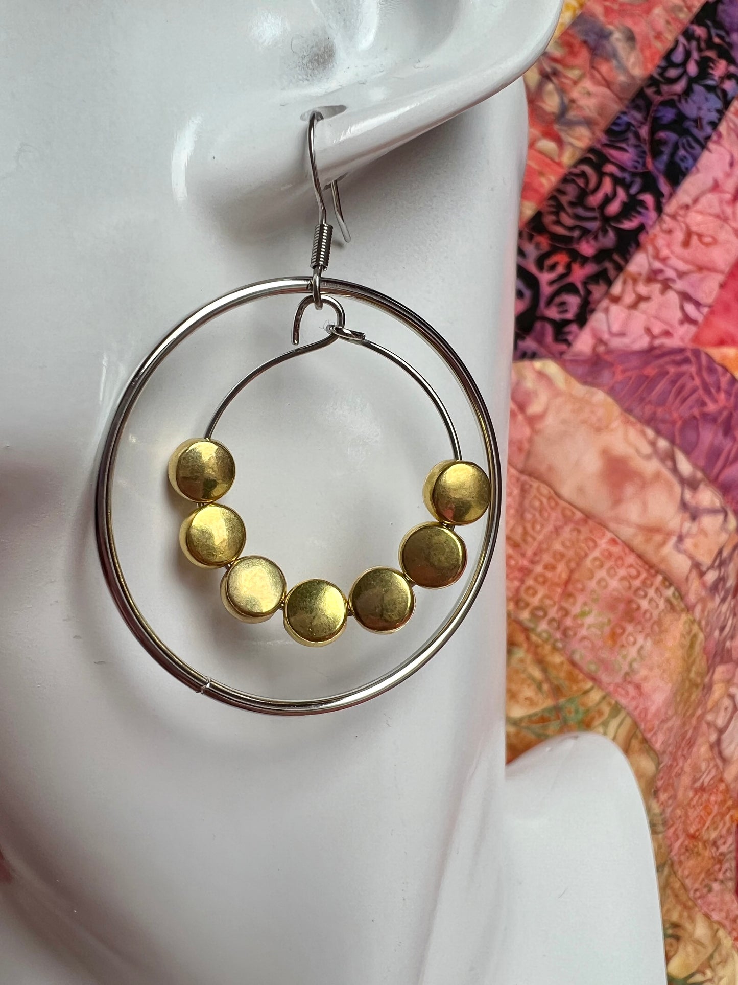 Earrings- Stainless steel ear wires, silver plated metal with gold plated metal coin shaped beads.