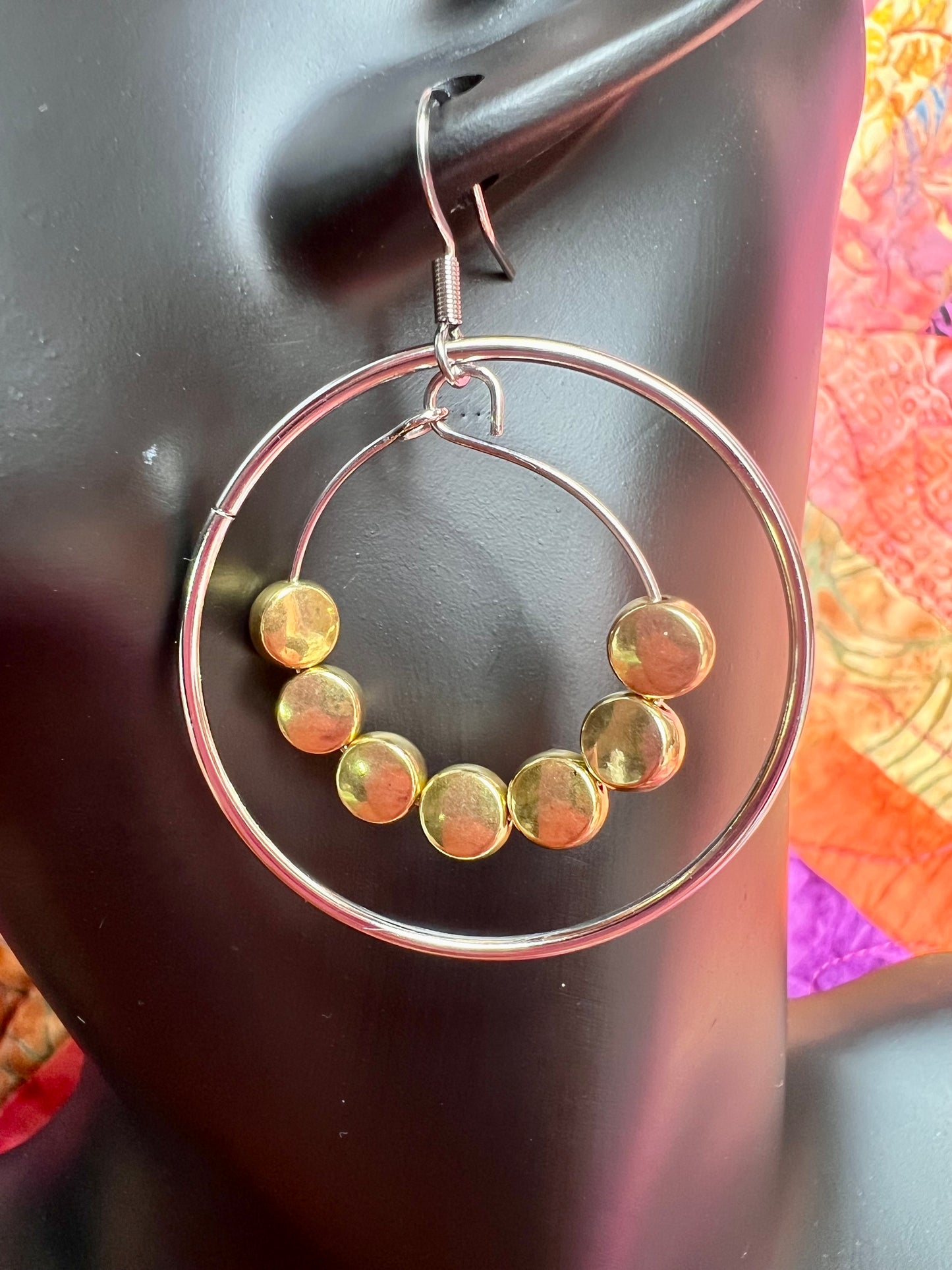 Earrings- Stainless steel ear wires, silver plated metal with gold plated metal coin shaped beads.