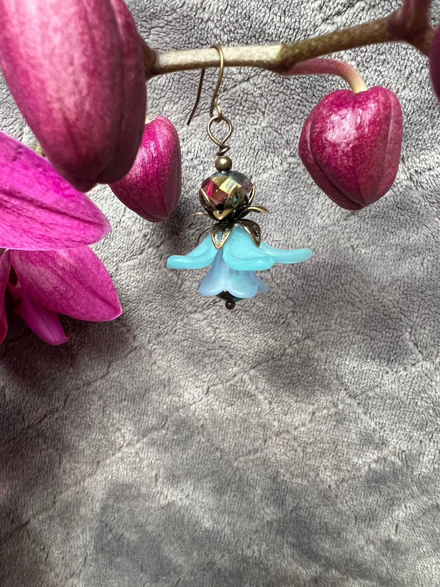 Earrings- Antique gold plated metal with blue acrylic flower beads and crystal.