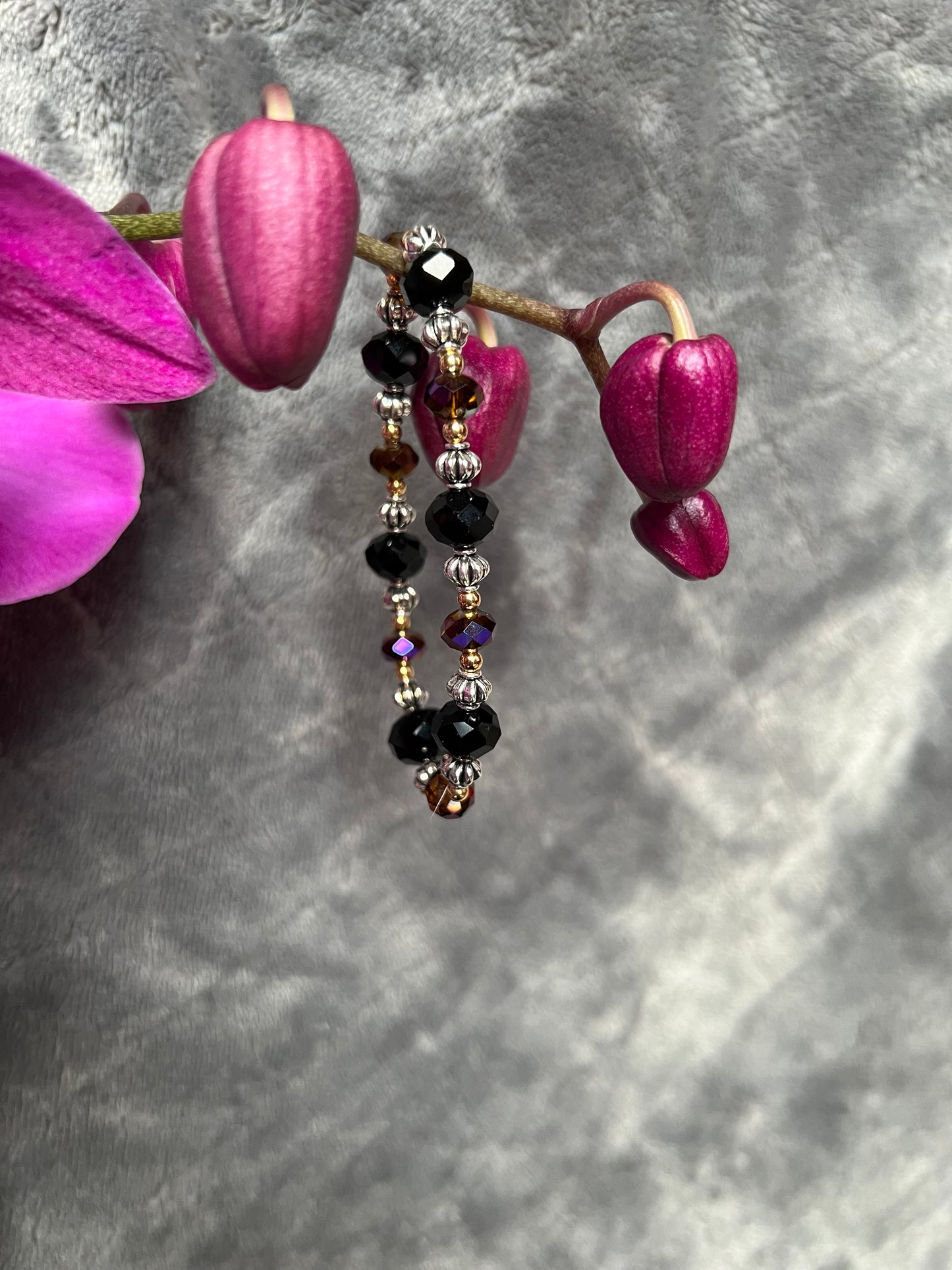 Bracelet- Silver and gold plated metal beads with black & brown topaz crystals.