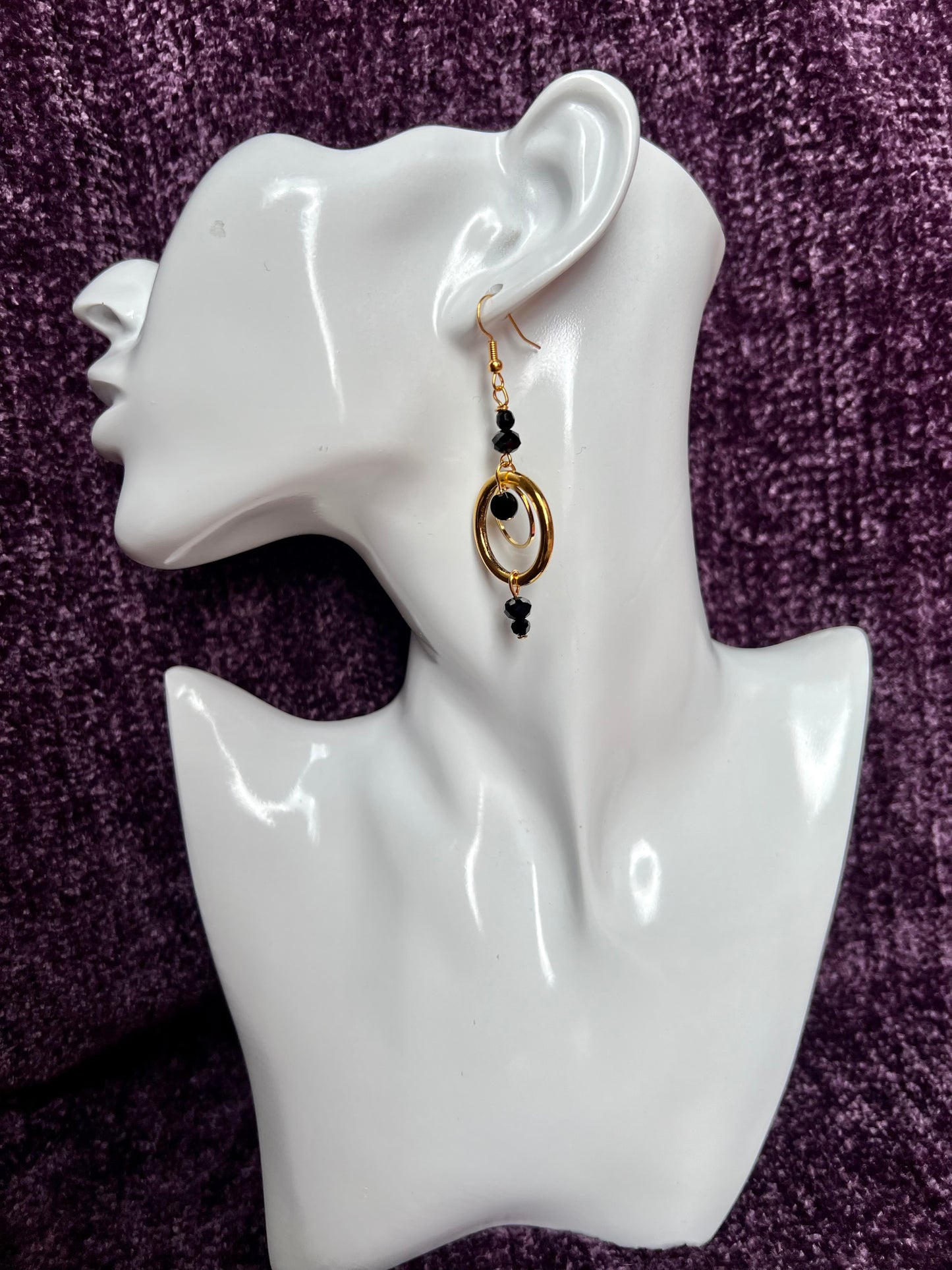 Earrings- Antiqued gold plated stainless steel ear hooks and metal hoops with opaque black crystals.