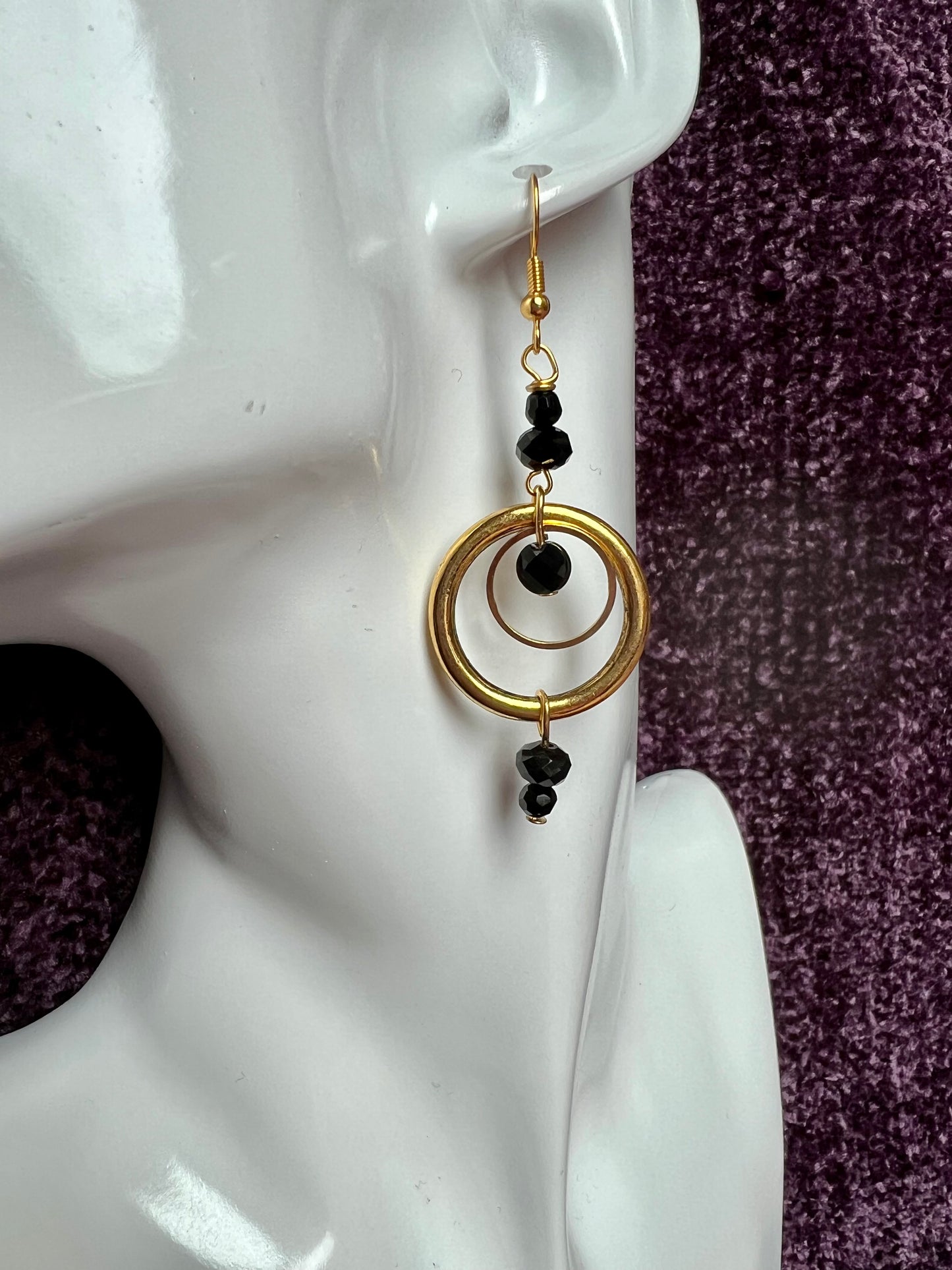 Earrings- Antiqued gold plated stainless steel ear hooks and metal hoops with opaque black crystals.