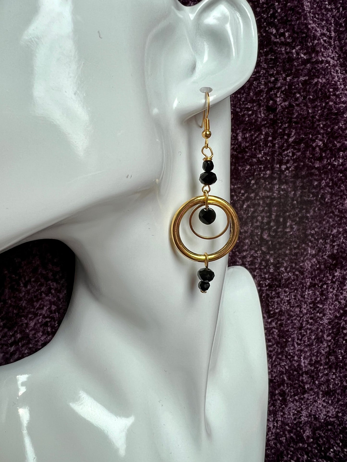 Earrings- Antiqued gold plated stainless steel ear hooks and metal hoops with opaque black crystals.