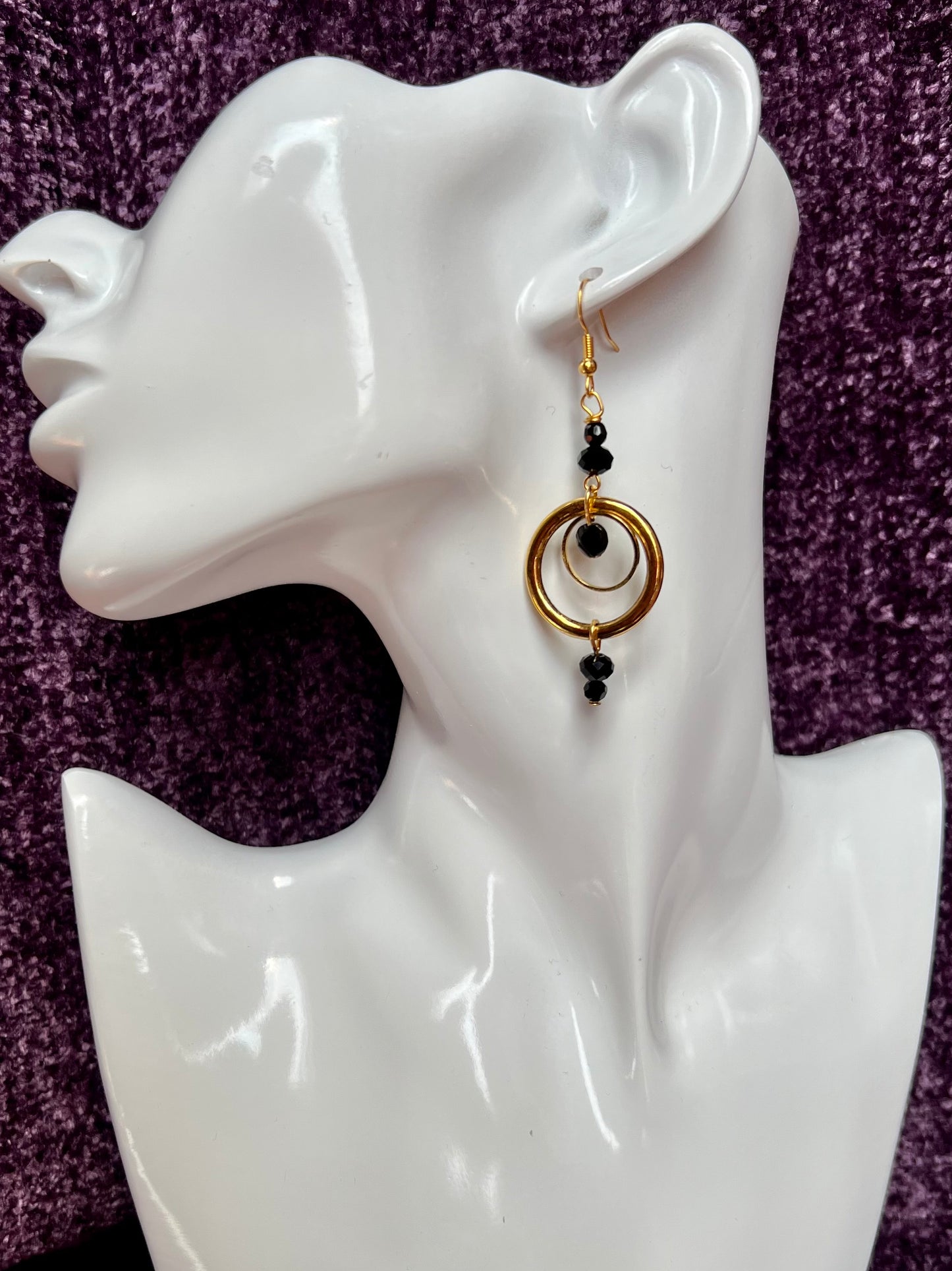 Earrings- Antiqued gold plated stainless steel ear hooks and metal hoops with opaque black crystals.