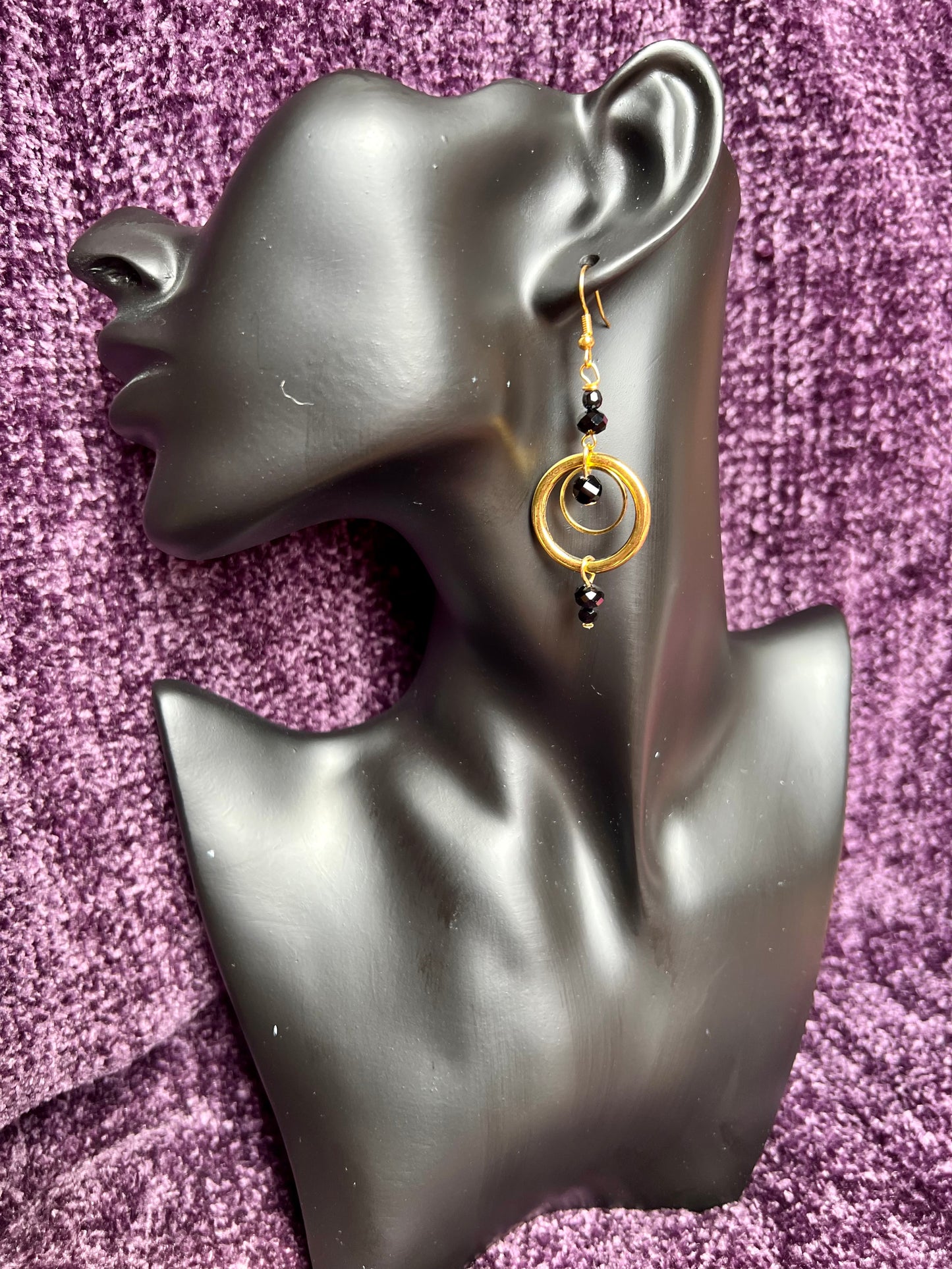 Earrings- Antiqued gold plated stainless steel ear hooks and metal hoops with opaque black crystals.