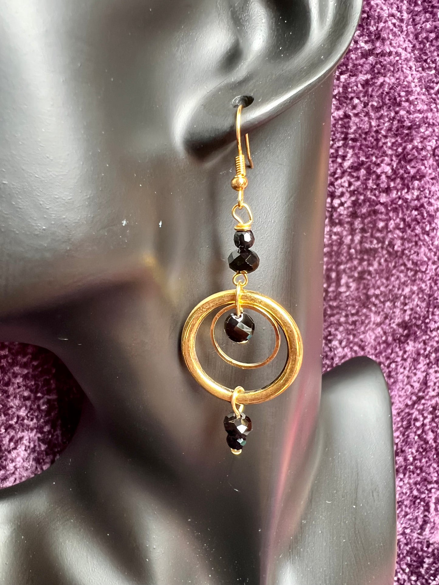 Earrings- Antiqued gold plated stainless steel ear hooks and metal hoops with opaque black crystals.