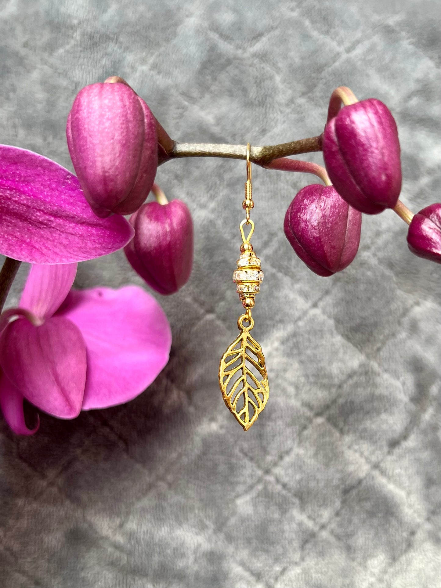 Earrings- Gold plated metal leaves with clear crystal rondelles.