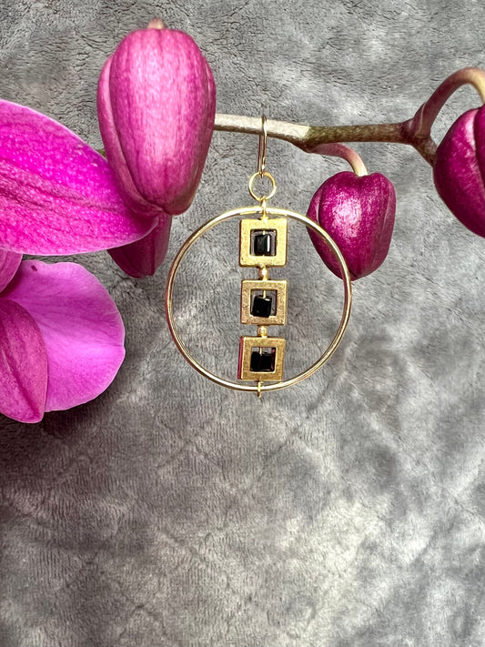 Earrings- Gold plated metal hoops with squares and black cube seed beads.