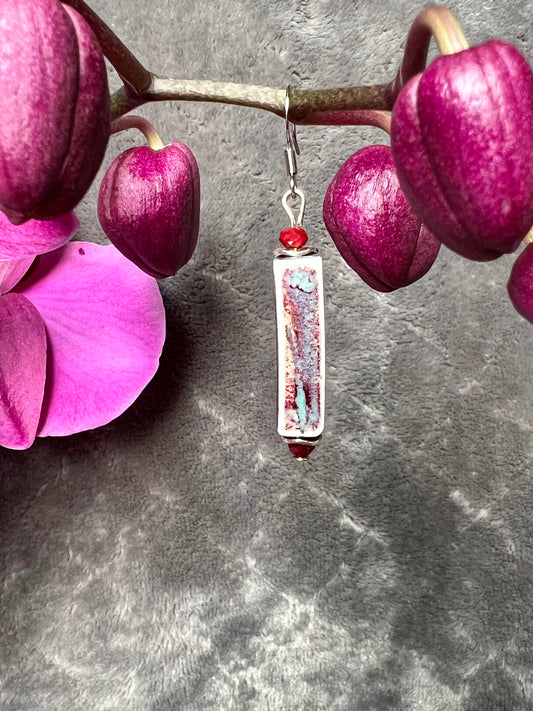 Earrings- Stainless steel ear hooks, red crystals, and ceramic rectangular tube beads in red and blue glaze.