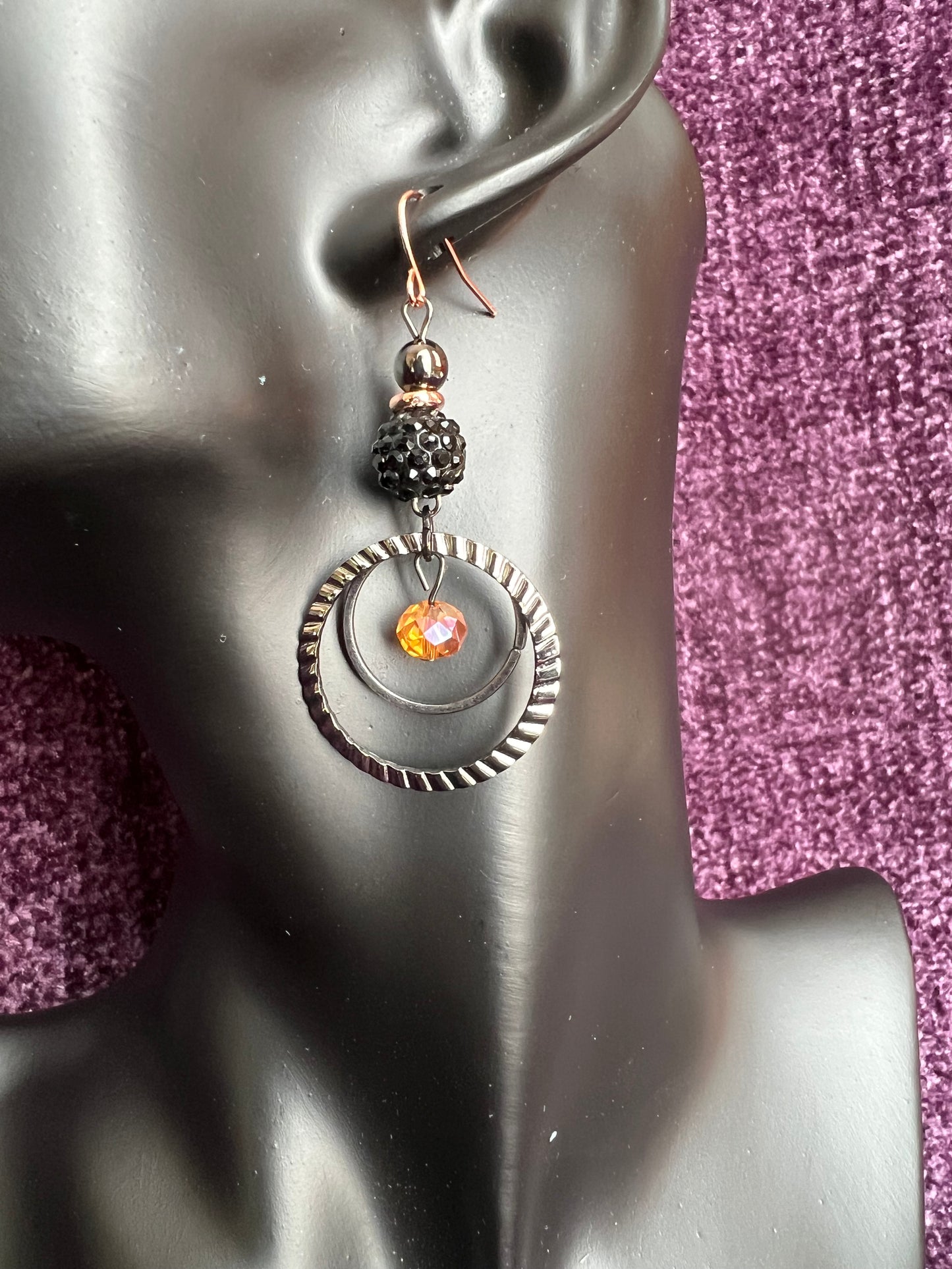 Earrings- Gun metal with copper plated ear wires & iridescent orange satin crystal.