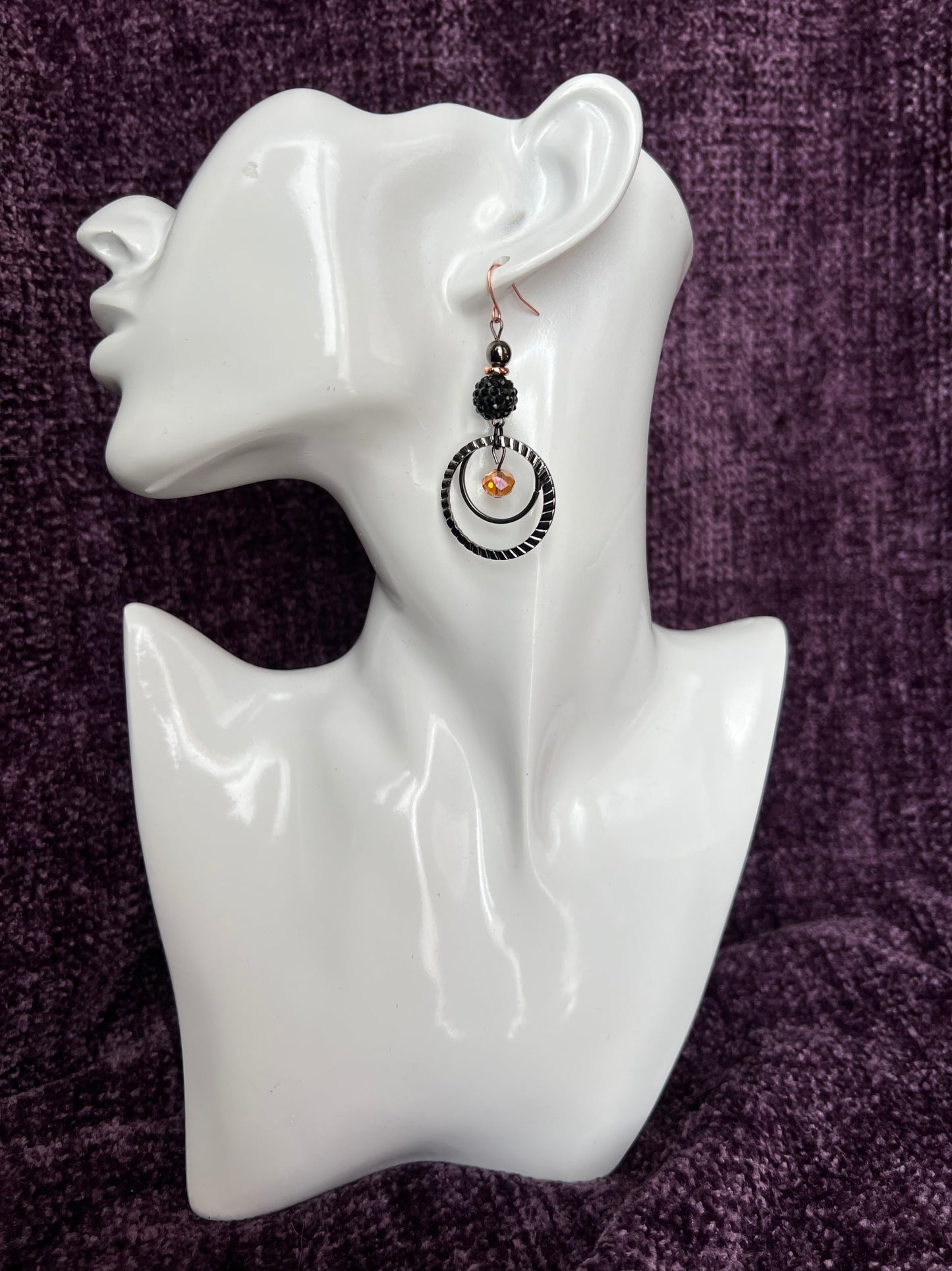 Earrings- Gun metal with copper plated ear wires & iridescent orange satin crystal.