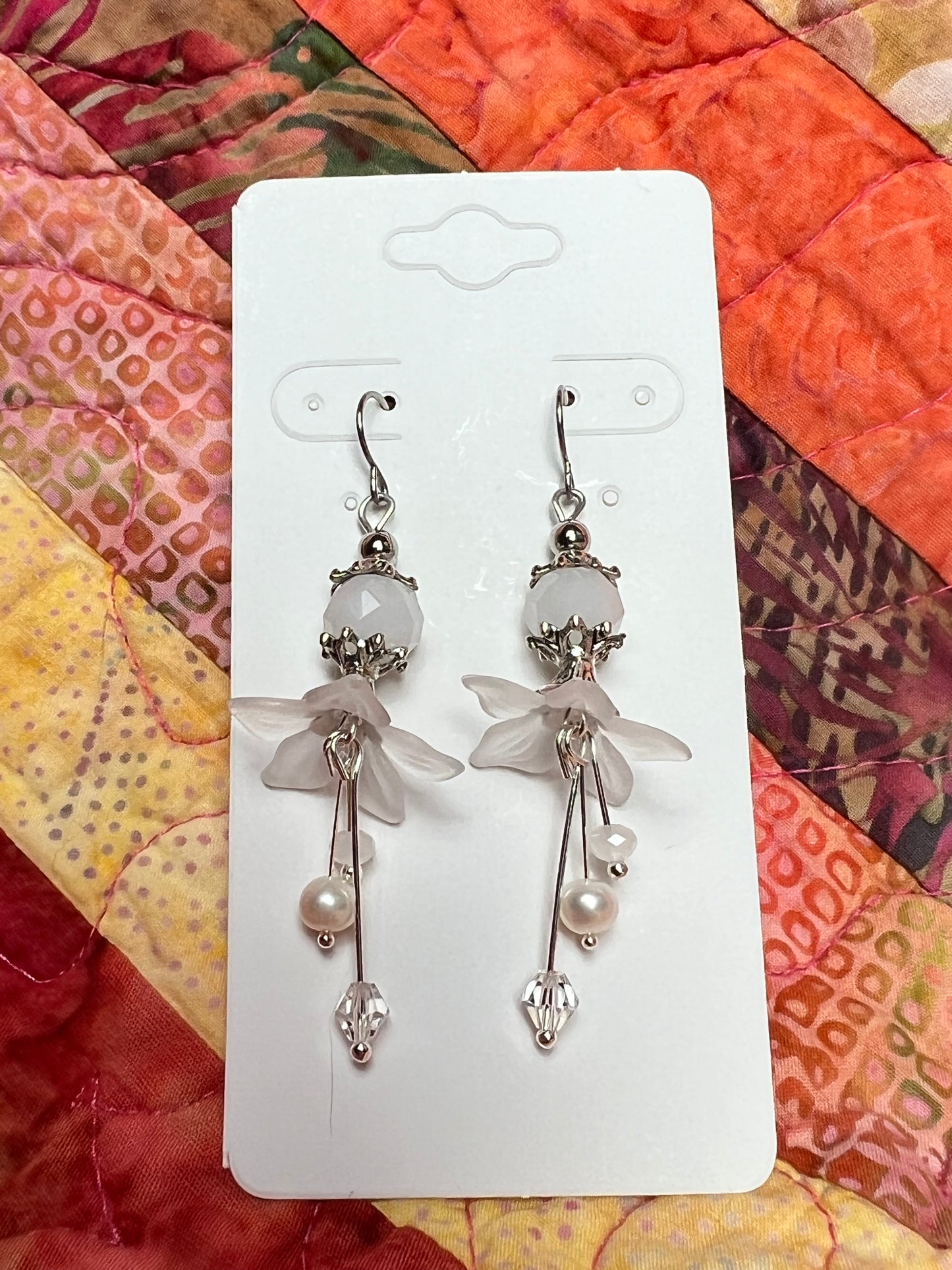 Earrings- Silver plated metal with fresh water pearls, crystals, and white acrylic flowers.