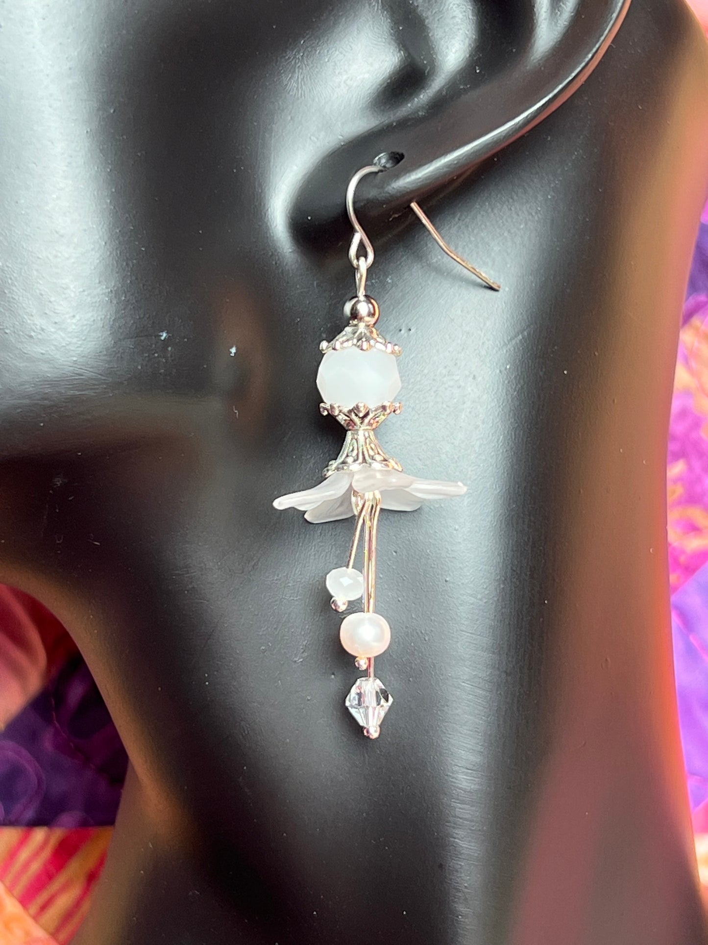 Earrings- Silver plated metal with fresh water pearls, crystals, and white acrylic flowers.