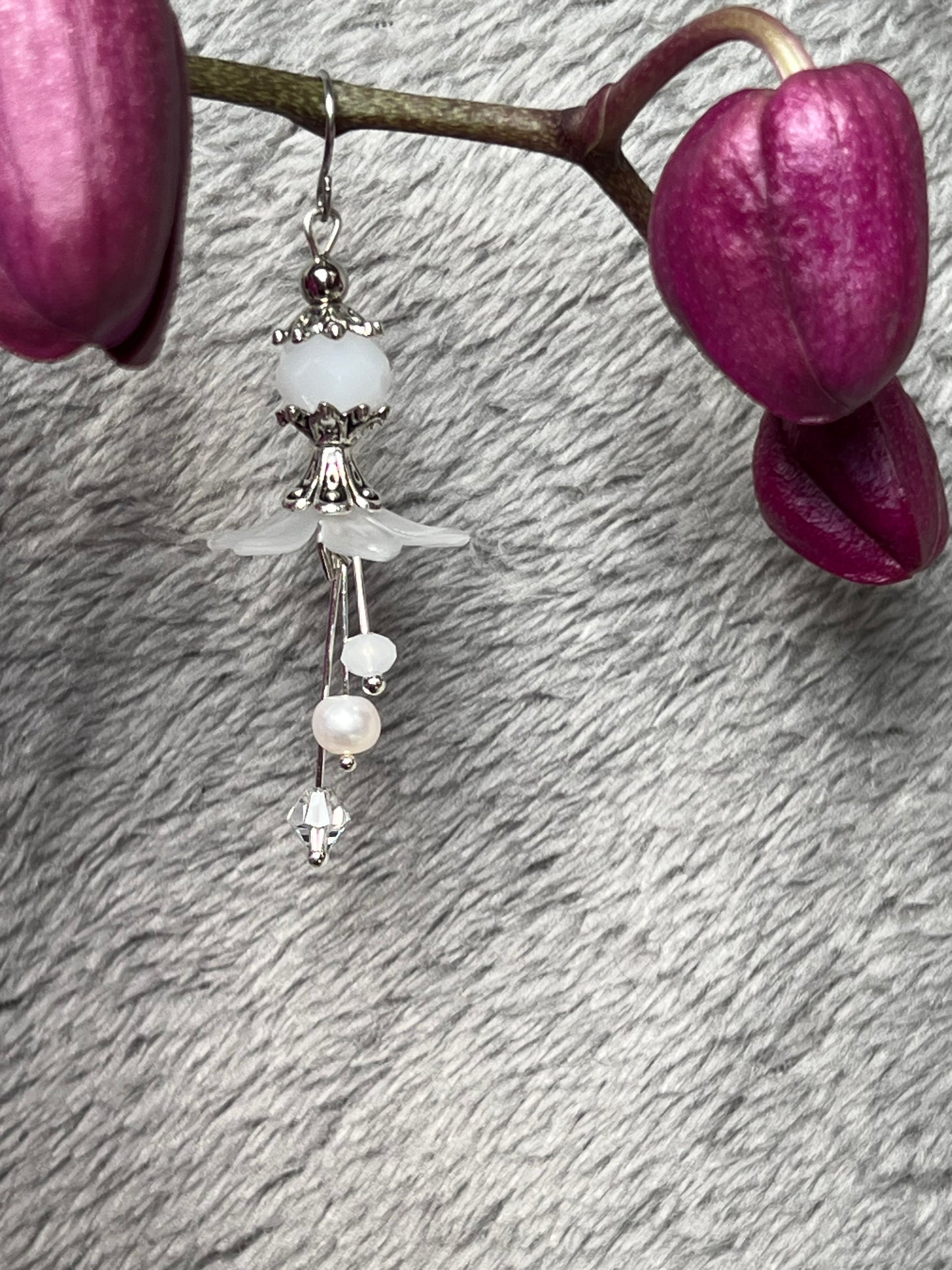 Earrings- Silver plated metal with fresh water pearls, crystals, and white acrylic flowers.