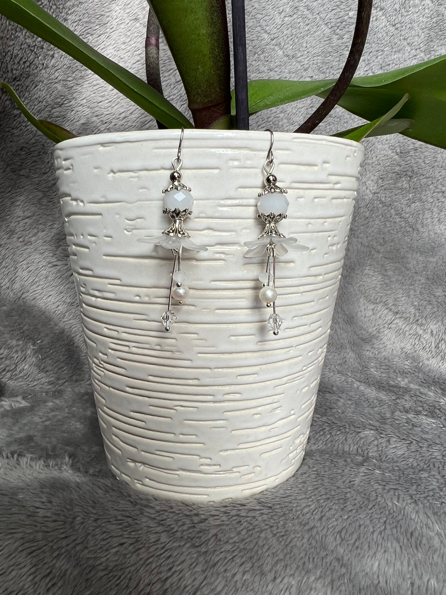 Earrings- Silver plated metal with fresh water pearls, crystals, and white acrylic flowers.