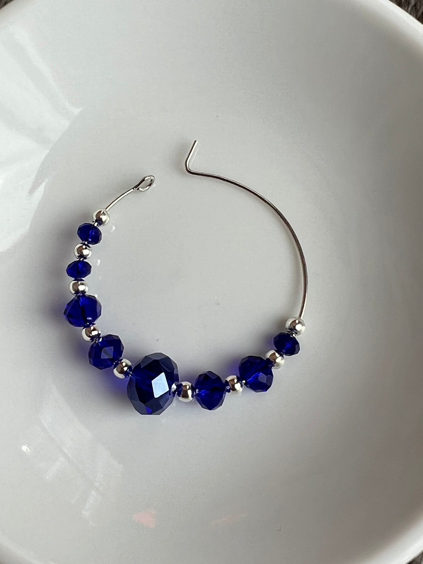 Earrings- Silver plated metal with cobalt blue crystal beads.