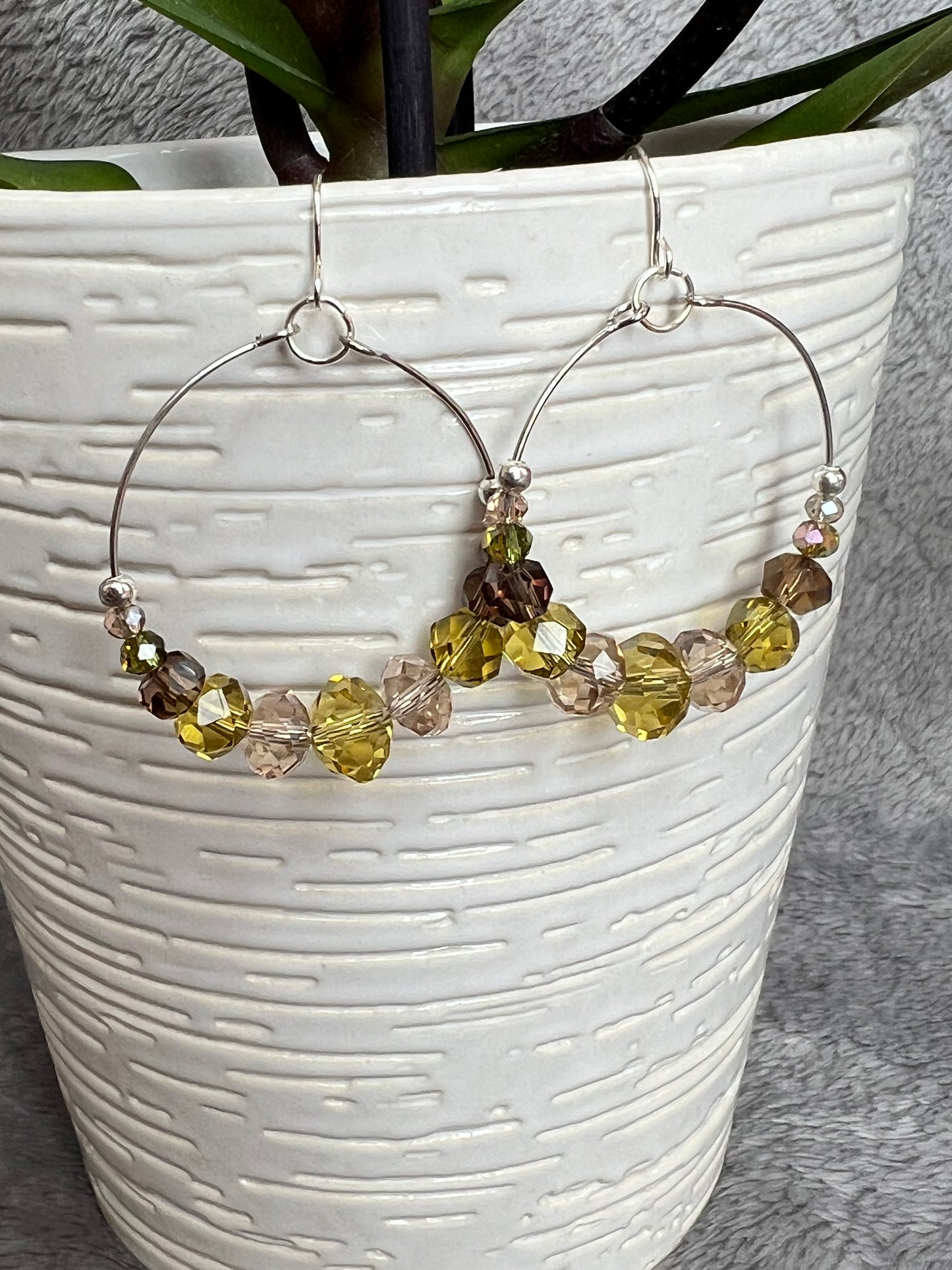 Earrings- Silver plated metal with cream, smoky quartz, & olive green crystal beads.