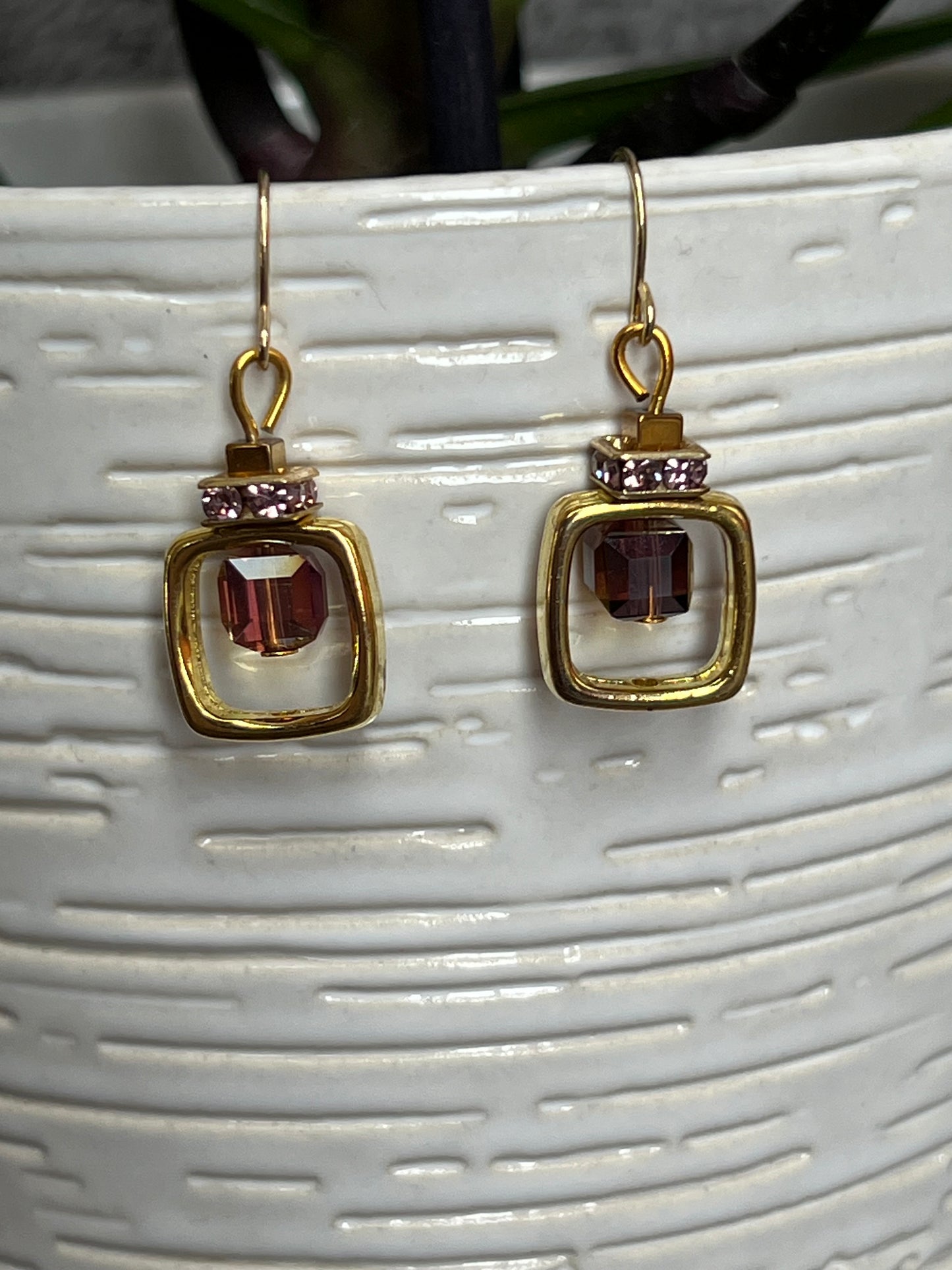 Earrings- Gold plated metal with purple crystal inside square.