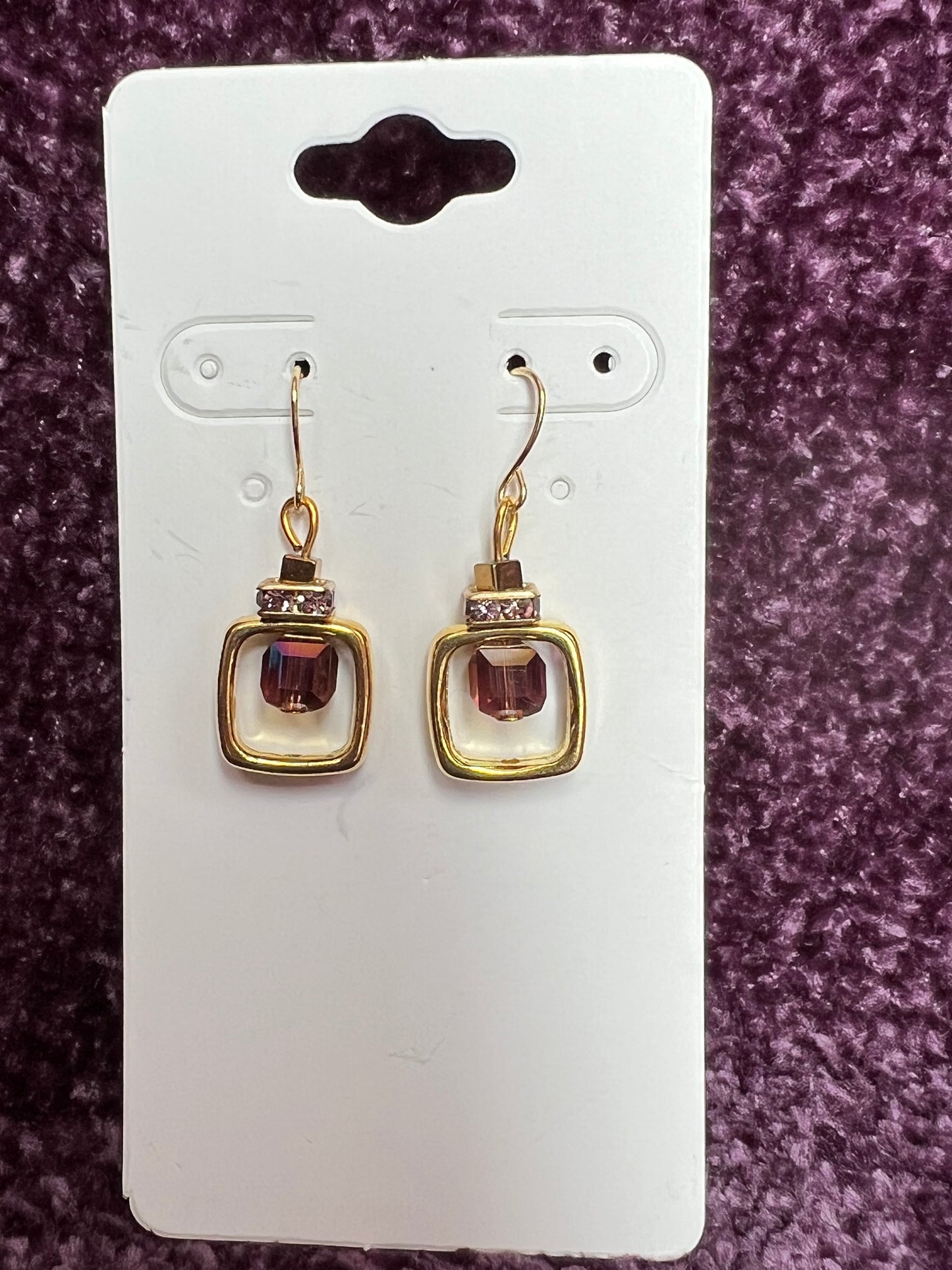 Earrings- Gold plated metal with purple crystal inside square.