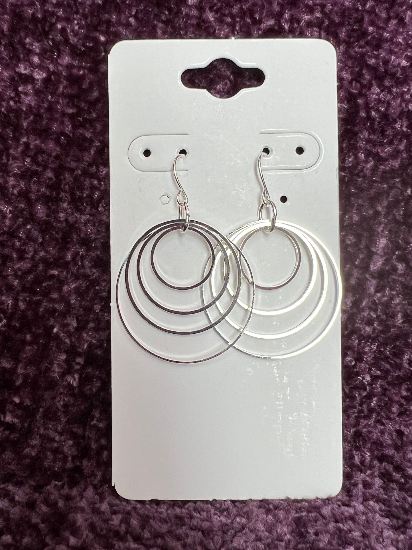 Earrings- Silver plated hoops of various sizes.