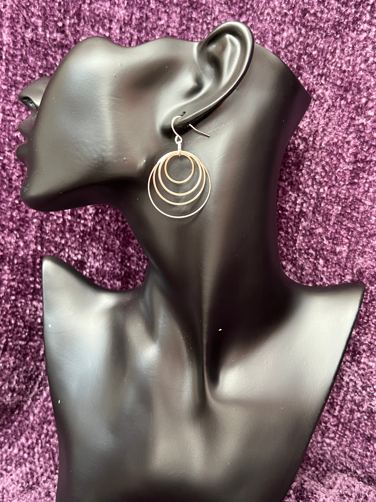 Earrings- Silver plated hoops of various sizes.