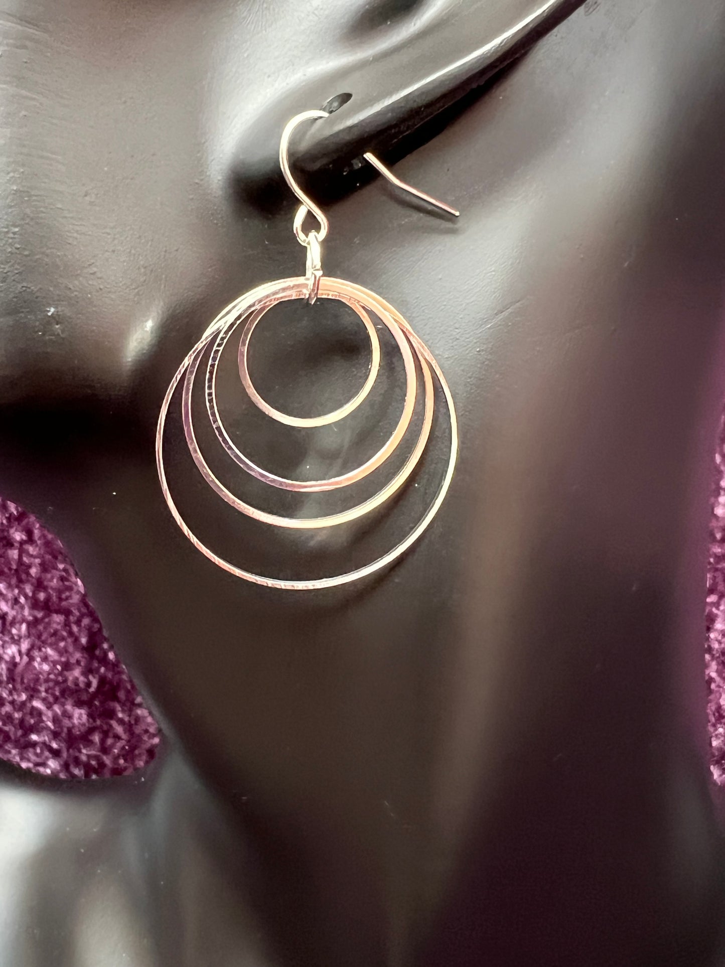 Earrings- Silver plated hoops of various sizes.