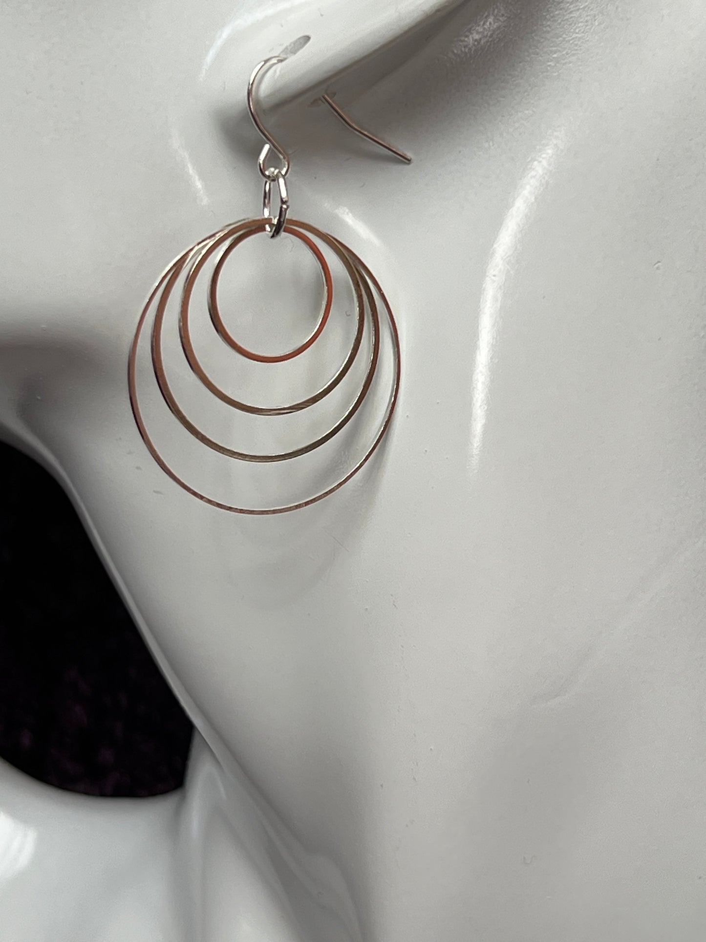 Earrings- Silver plated hoops of various sizes.