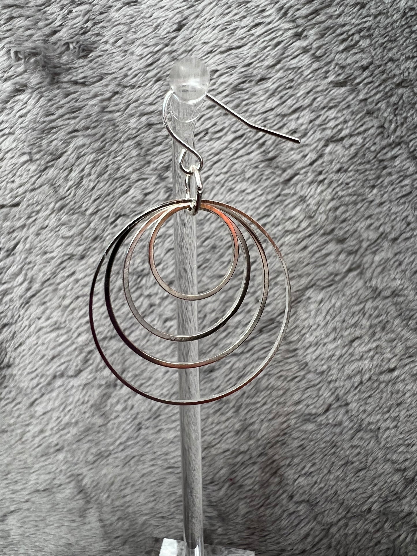 Earrings- Silver plated hoops of various sizes.